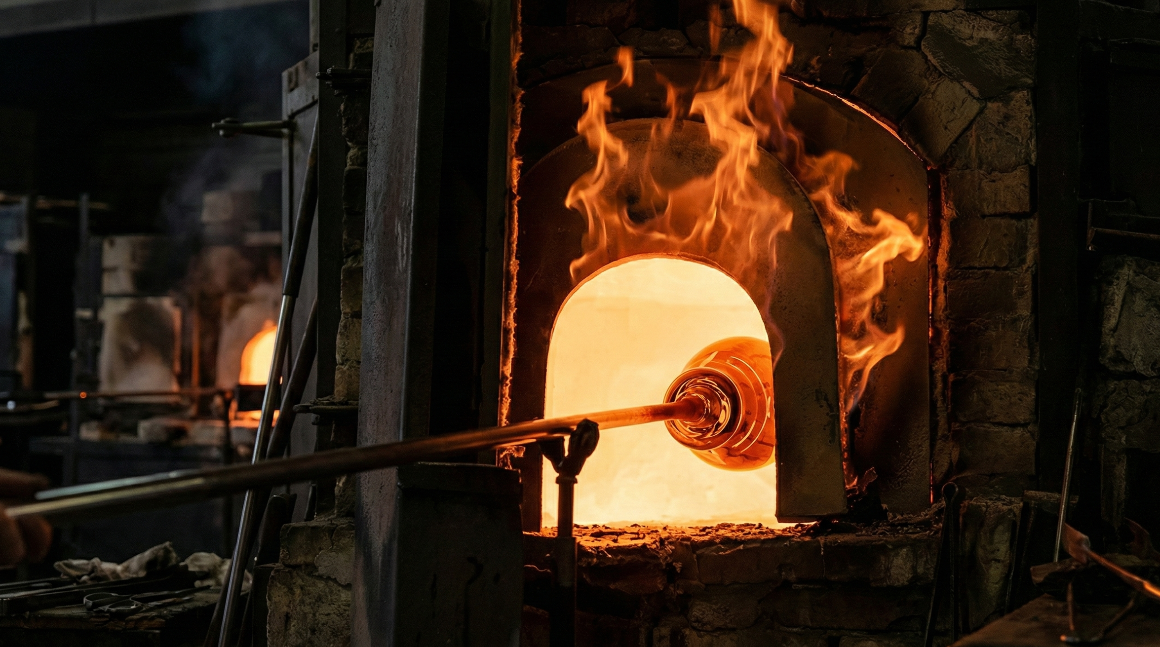 Glassblowing furnace with glowing molten glass and flames. Sotokler Studio offerr design procurement and manufacturing services for interior designers globally. Custom made and vintage furniture & fixtures, including Murano glass lighting.