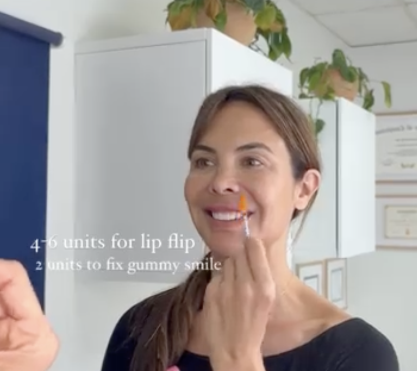 pointing a syringe to area for botox on face