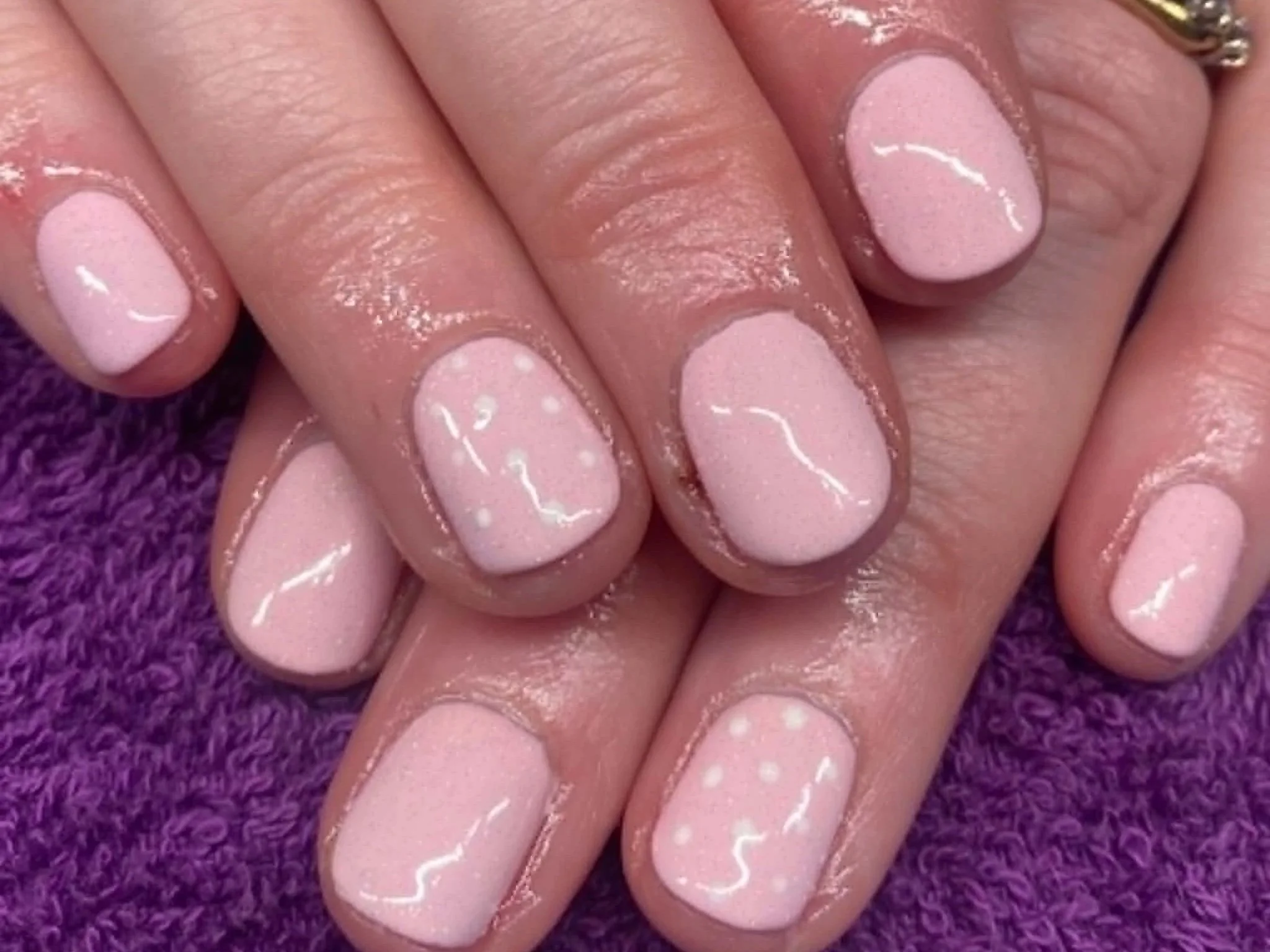 Client with pink nails with white polka dots