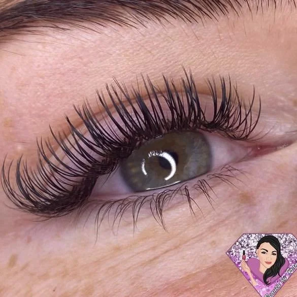 Close-up of a person’s eye with long, curled eyelashes and well-groomed eyebrows.