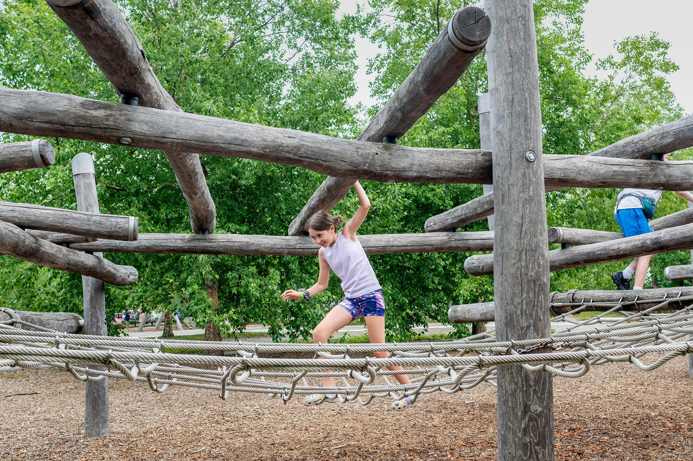 A young girl moves through a climbing feature on Governor's Island, Jun. 29, 2023. (For Friends of Governor's Island).