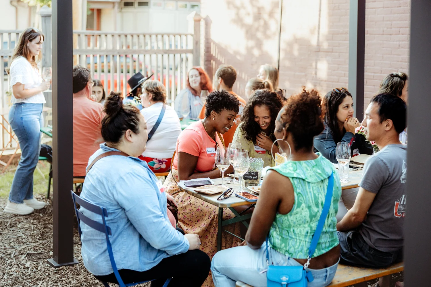 Guests enjoying conversation around a long outdoor table