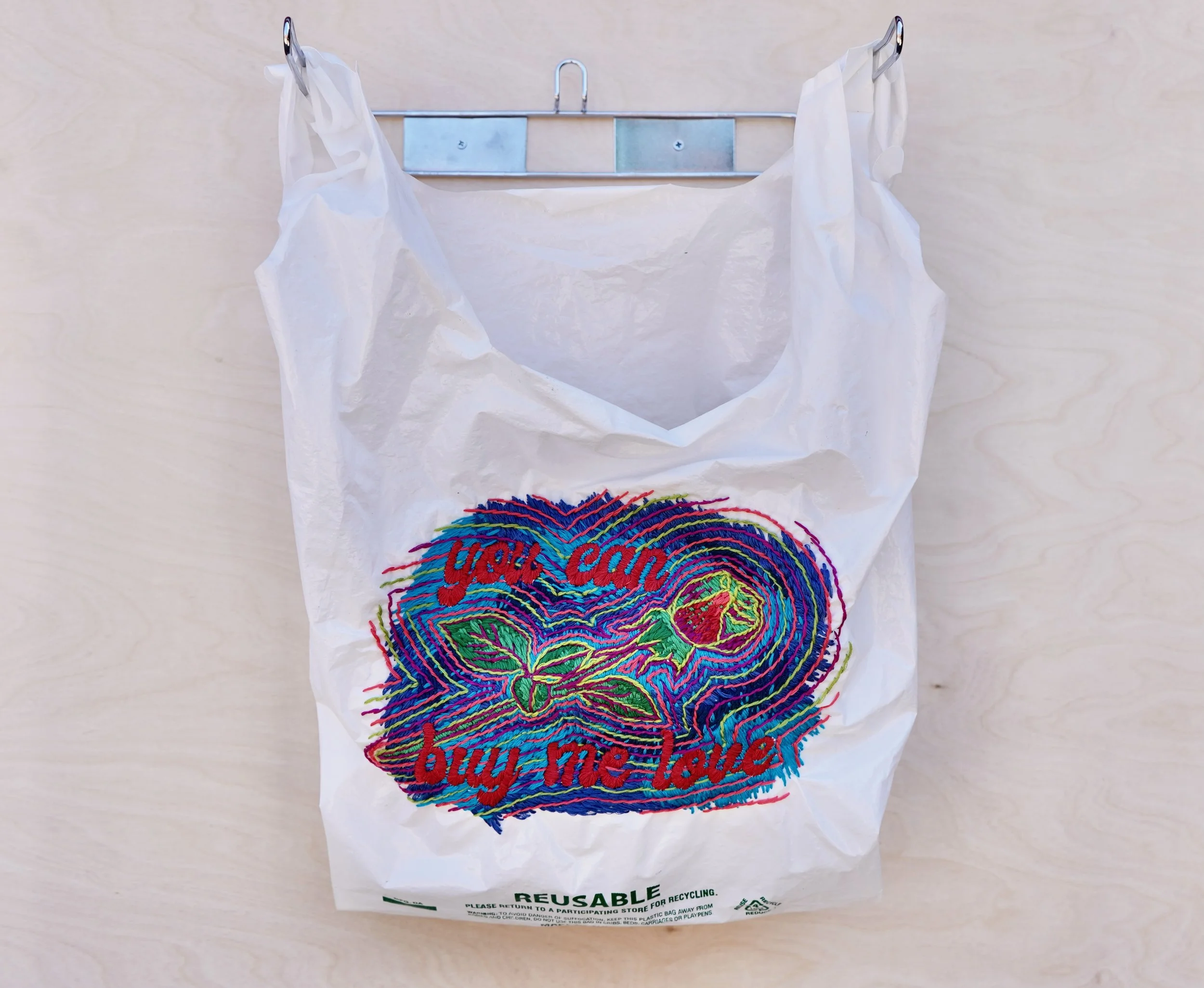 you can buy me love, 2021. Hand embroidery on plastic bag.