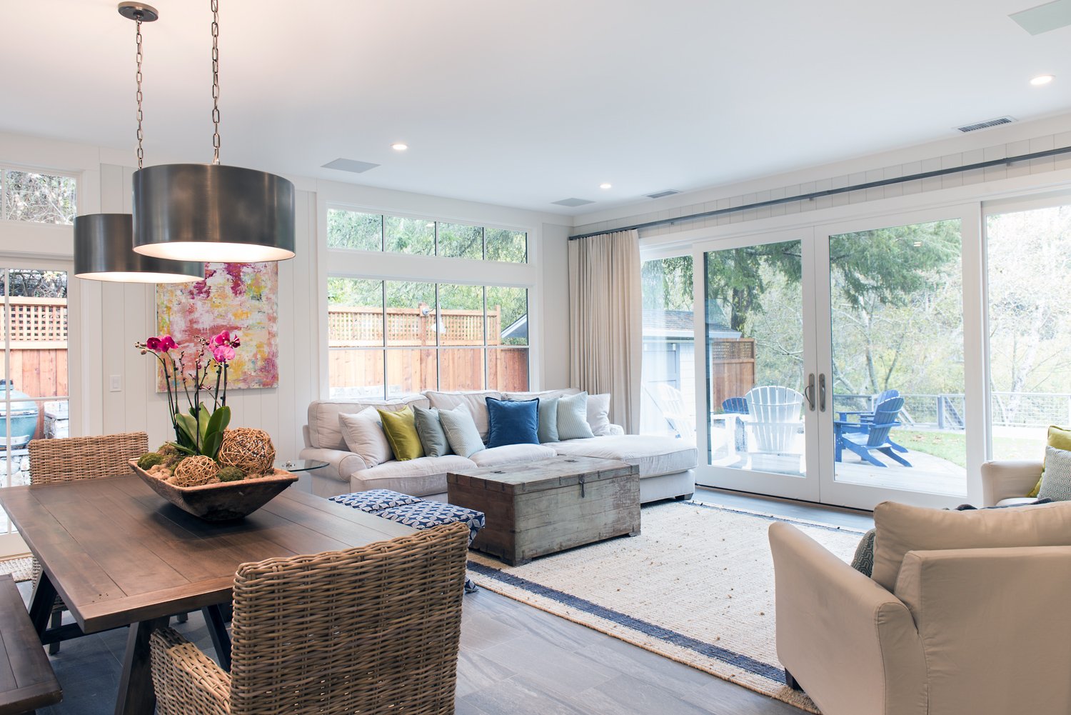  A living space with a white couch topped with colorful pillows.  