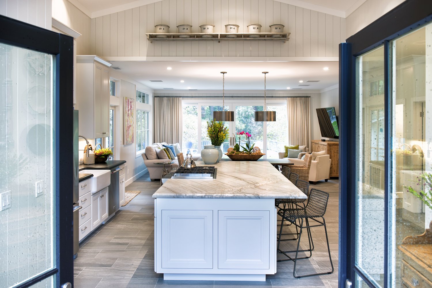  A kitchen island with an overhanging marble countertop.  