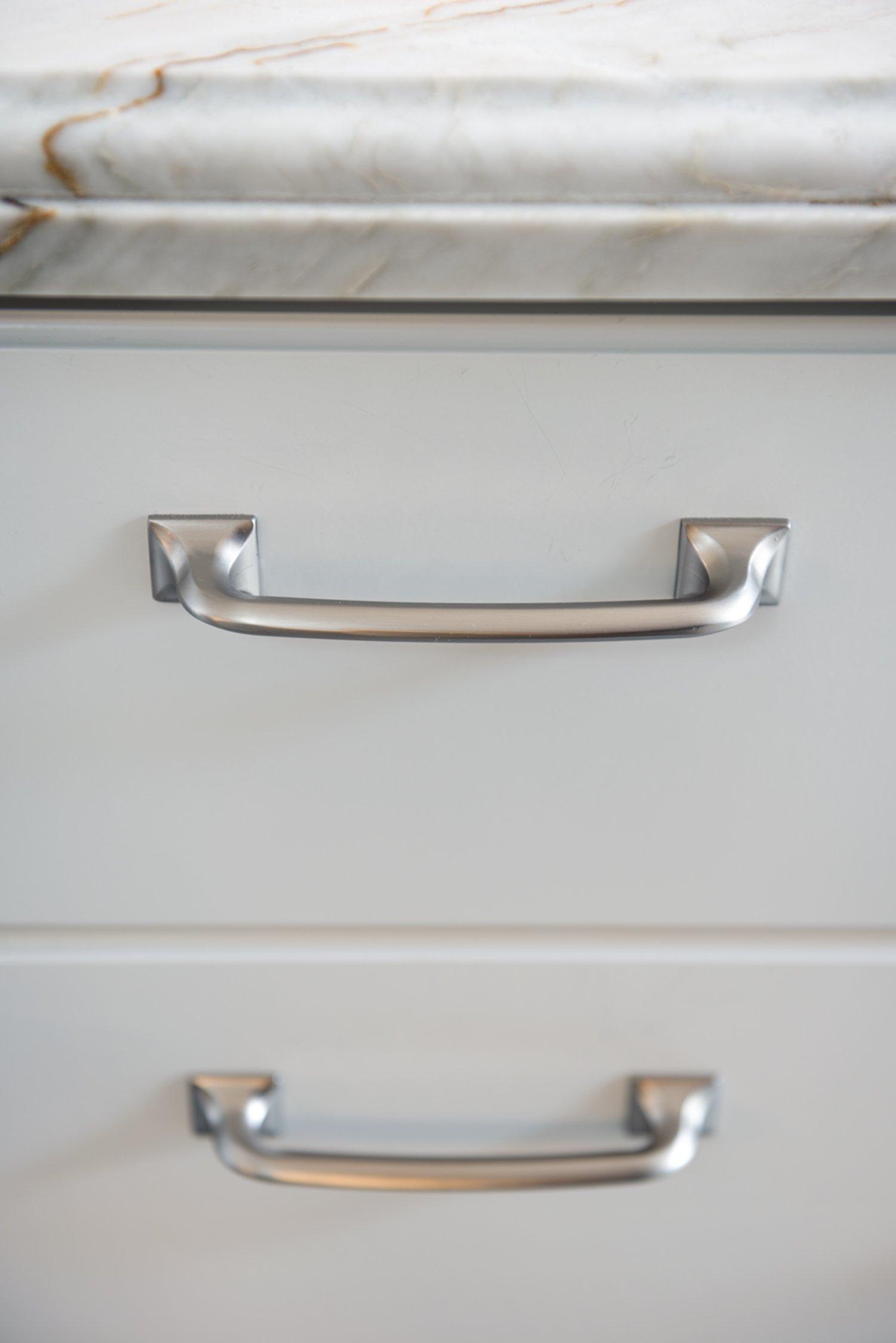  A close up of silver handle pulls.  