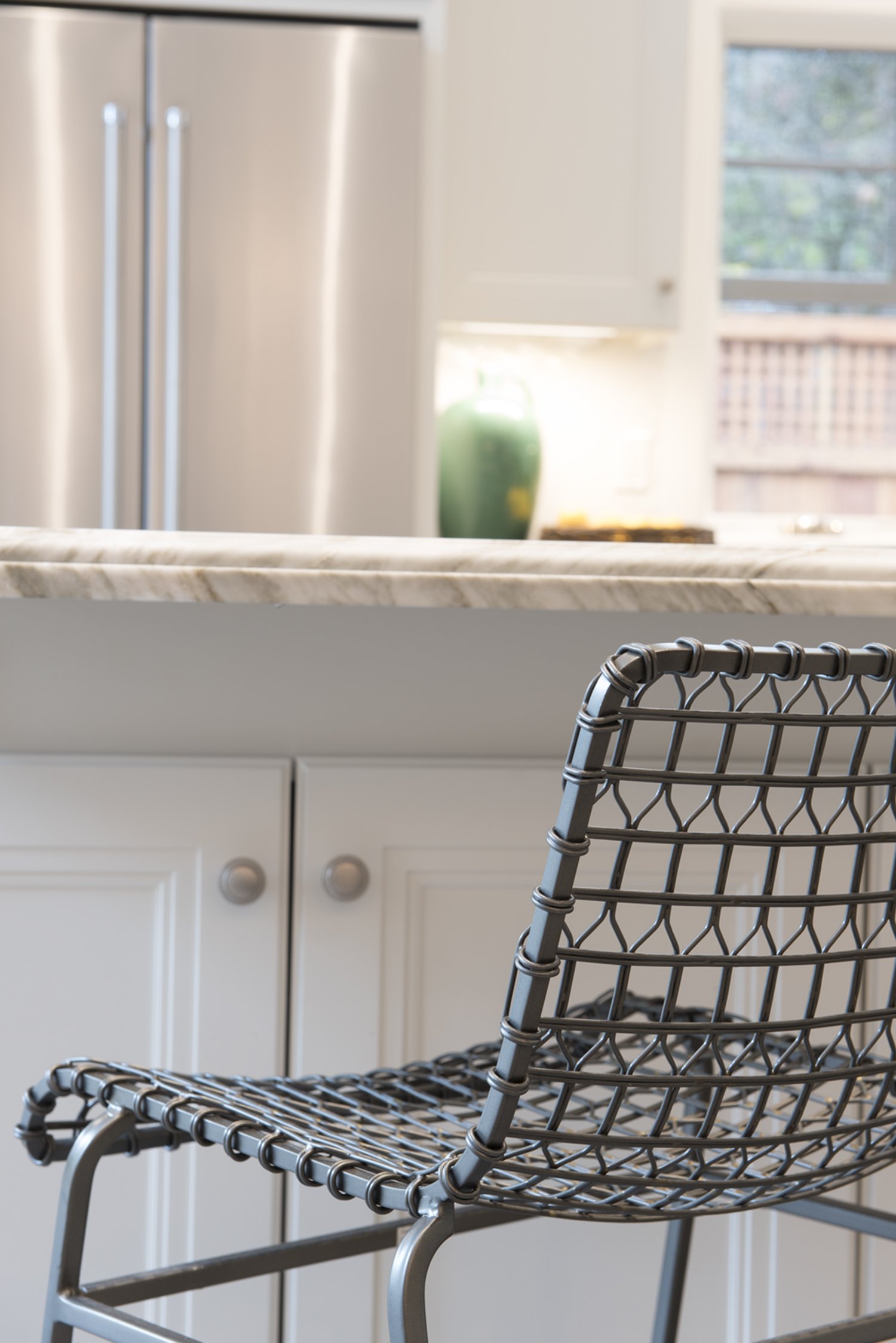  A close up of a woven metal bar stool.  