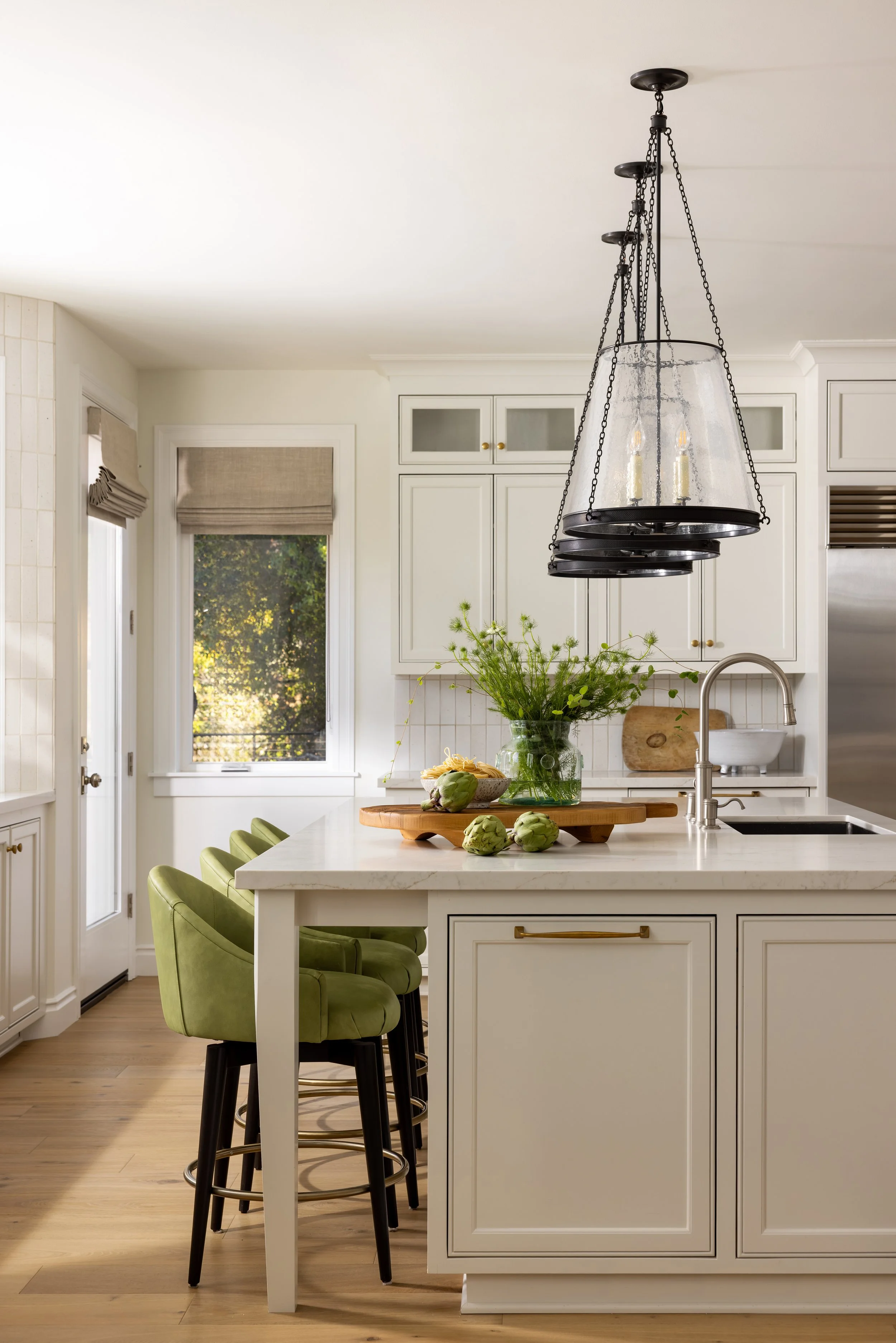 Kitchen island with quartz countertop, green velvet barstools, and black chain pendant light — Bartlett Residence by Tama Bell Design, Ukiah CA