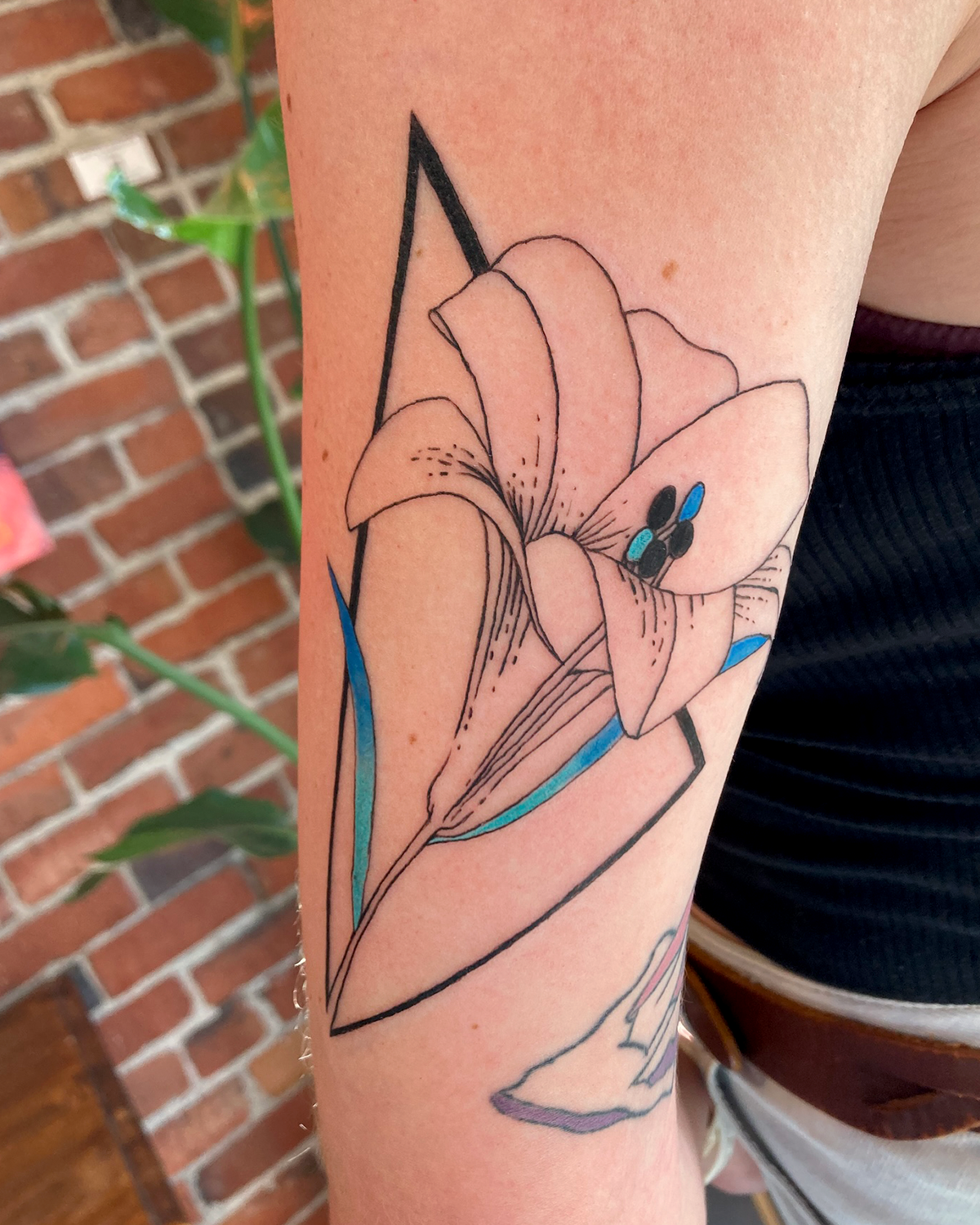 Geometric flower tattoo on forearm with triangle