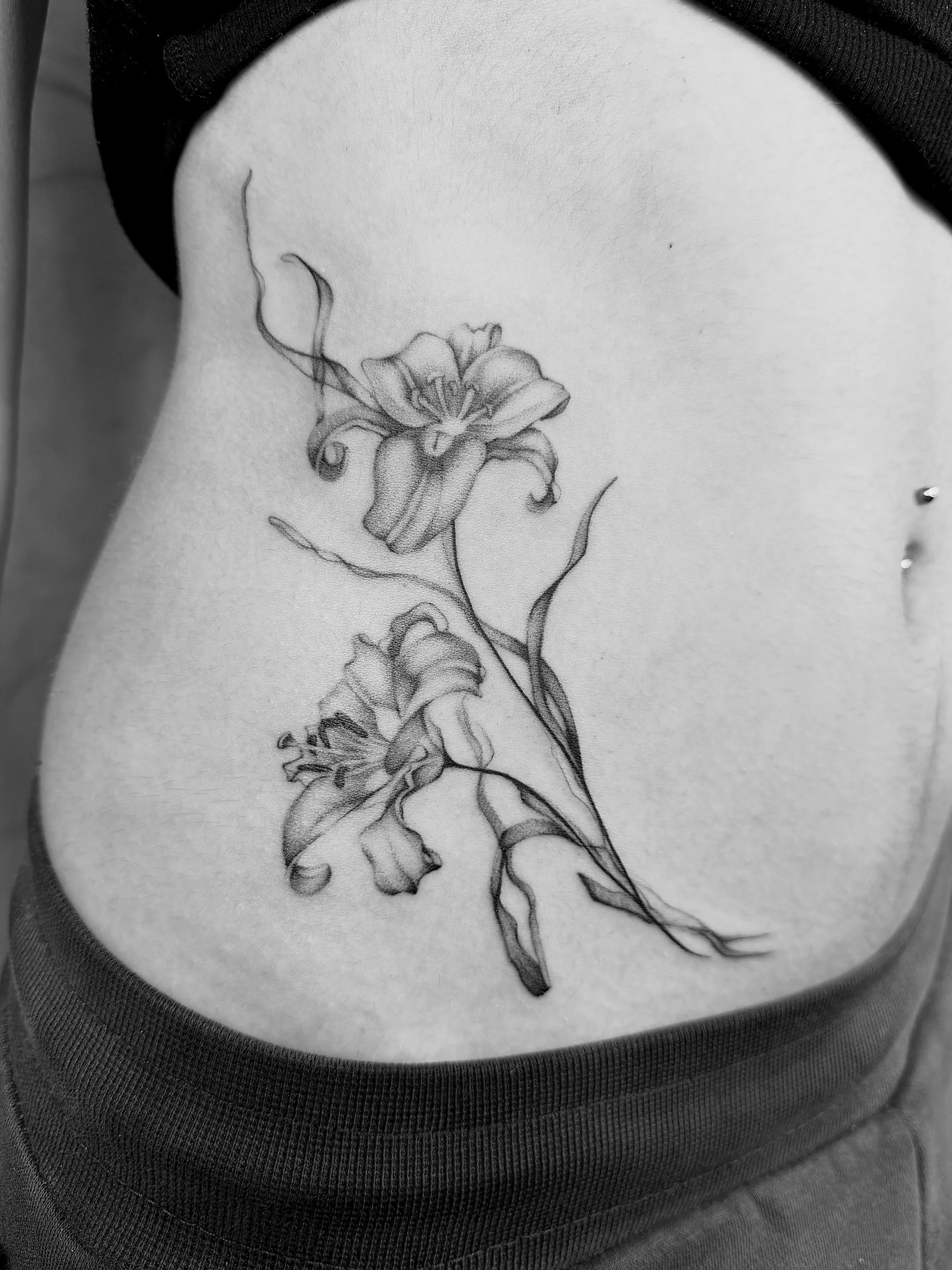 Soft shaded lilies by @danielbi.tattooart