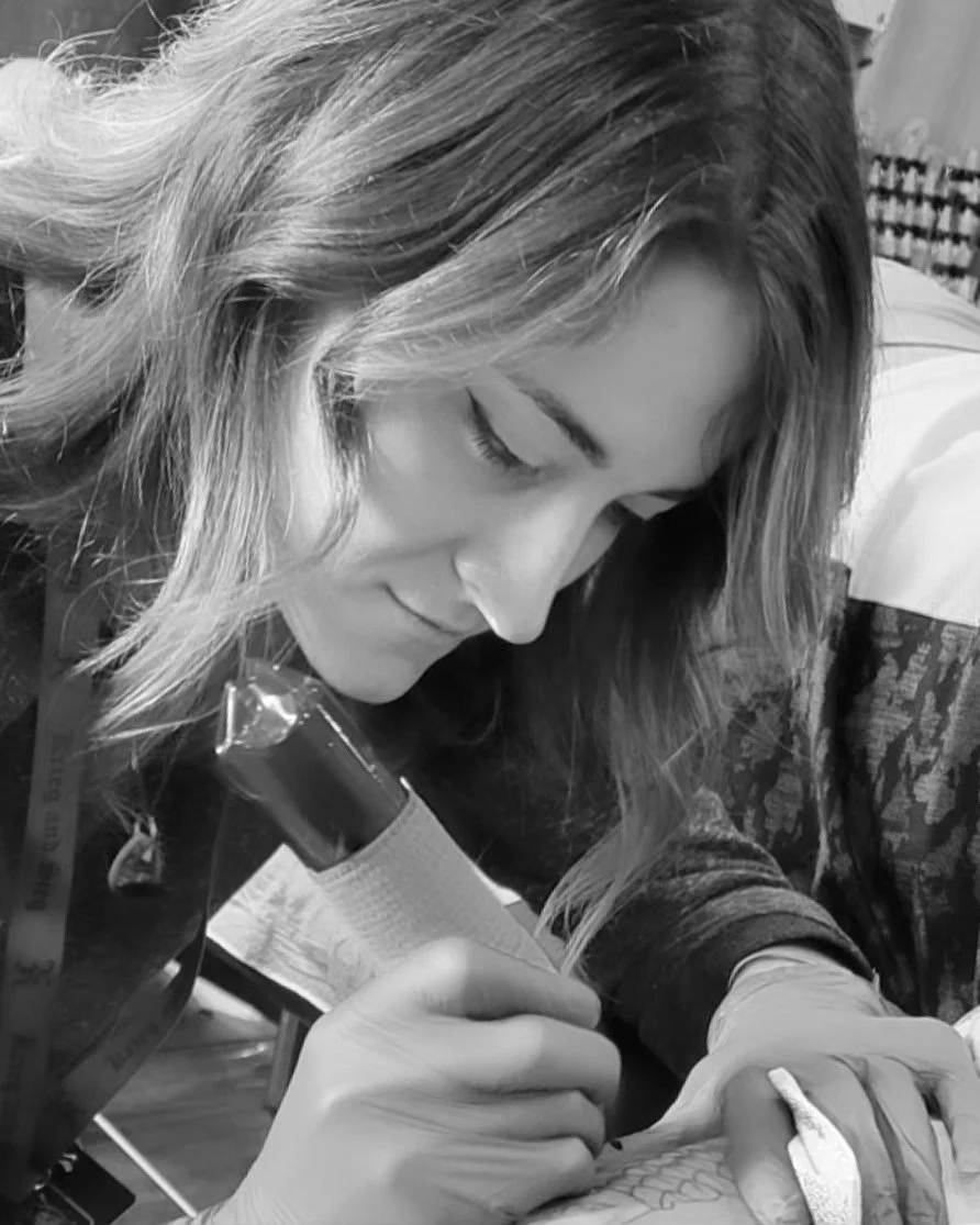 Tattoo artist focused on creating a tattoo design