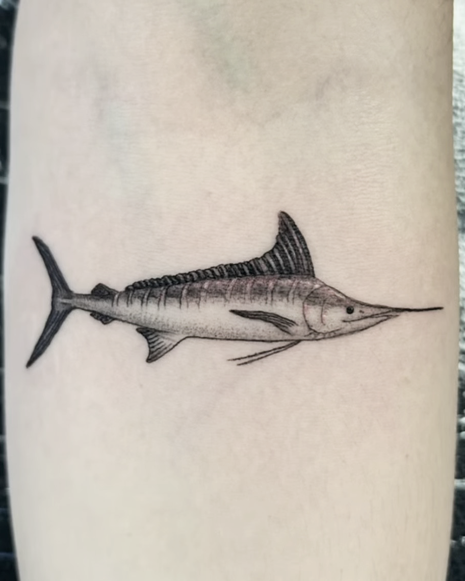 Blackwork microrealism tattoo of a swordfish on an arm.
