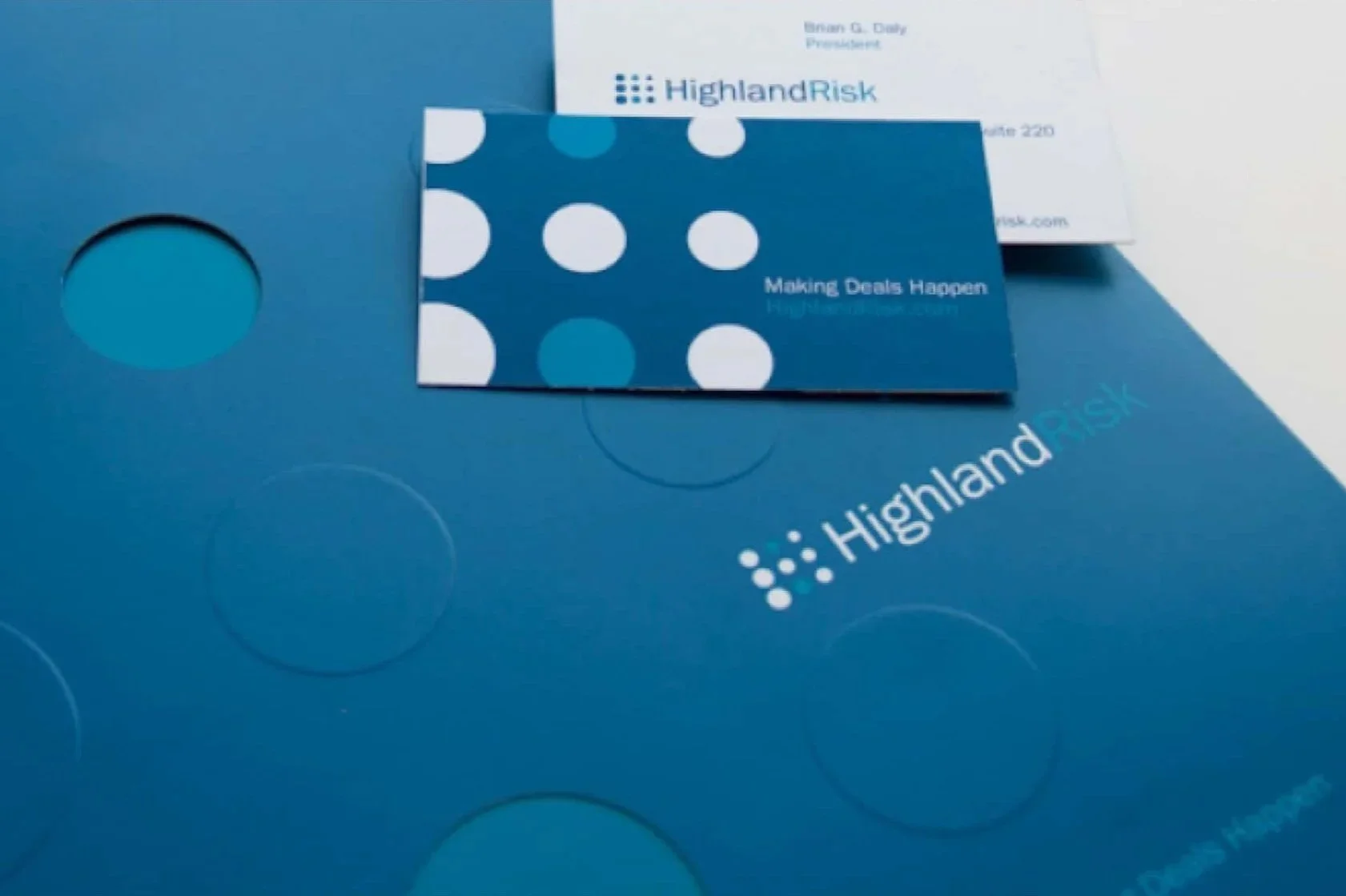 Highland Risk informational materials showing the logo created by rshanks, including business cards and brochures.