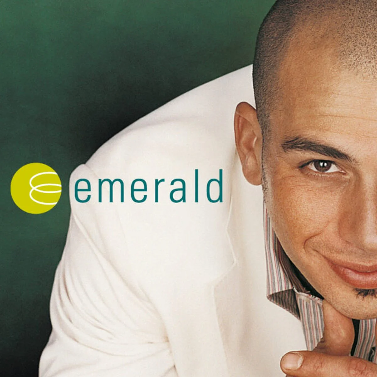 Close-up of a smiling man in a white jacket with the word 'emerald' and a green logo on a green background.