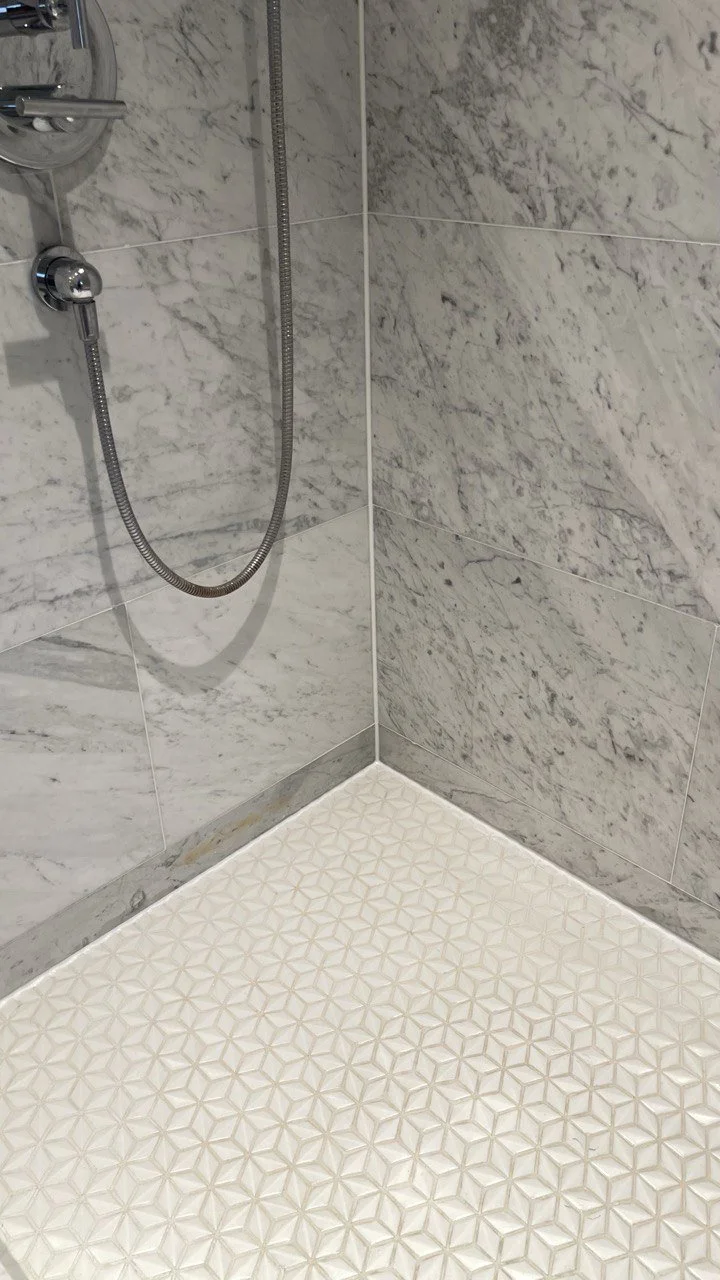 Newly repaired shower showing shower tile and grout restoration