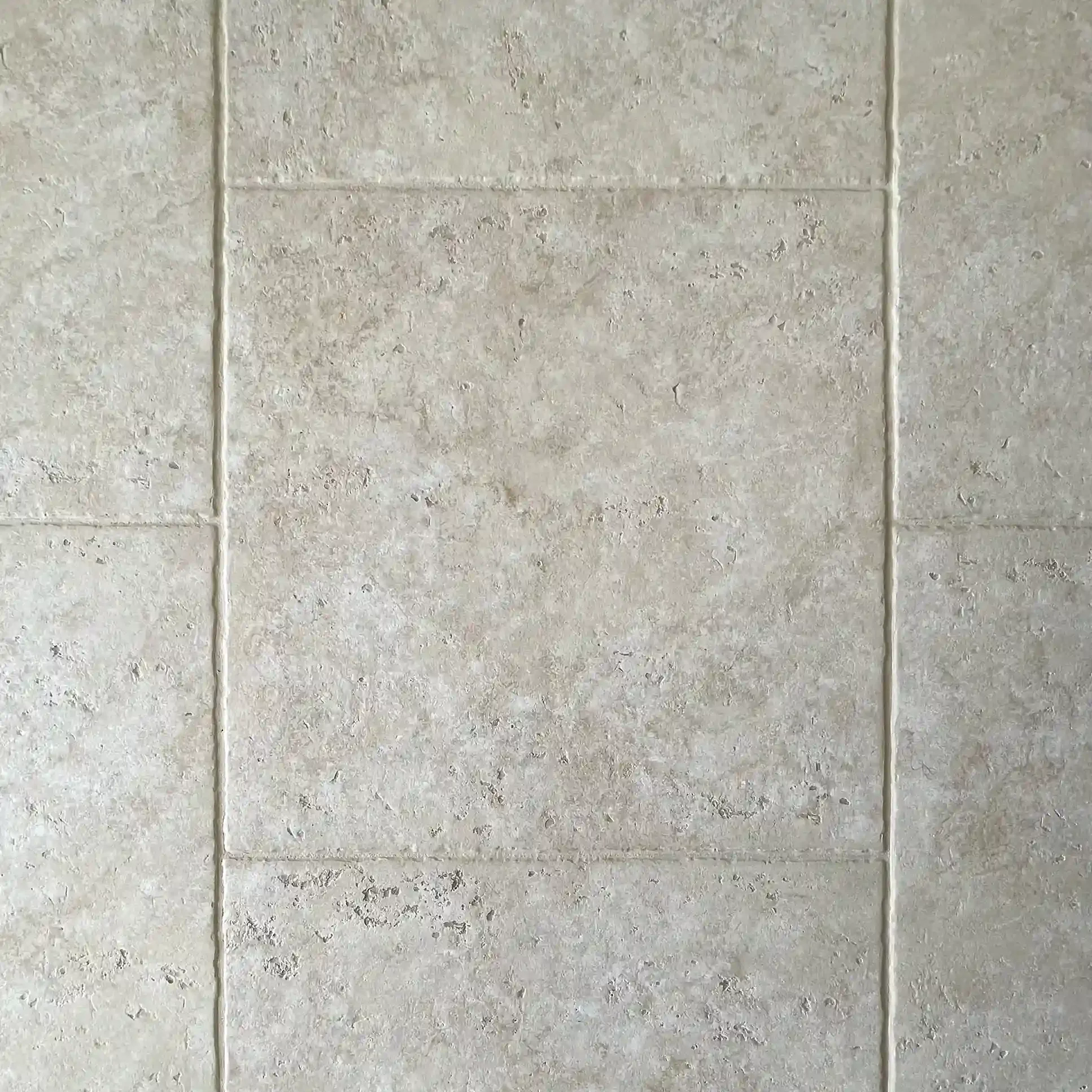 Close up of new grey floor tiles with grout lines