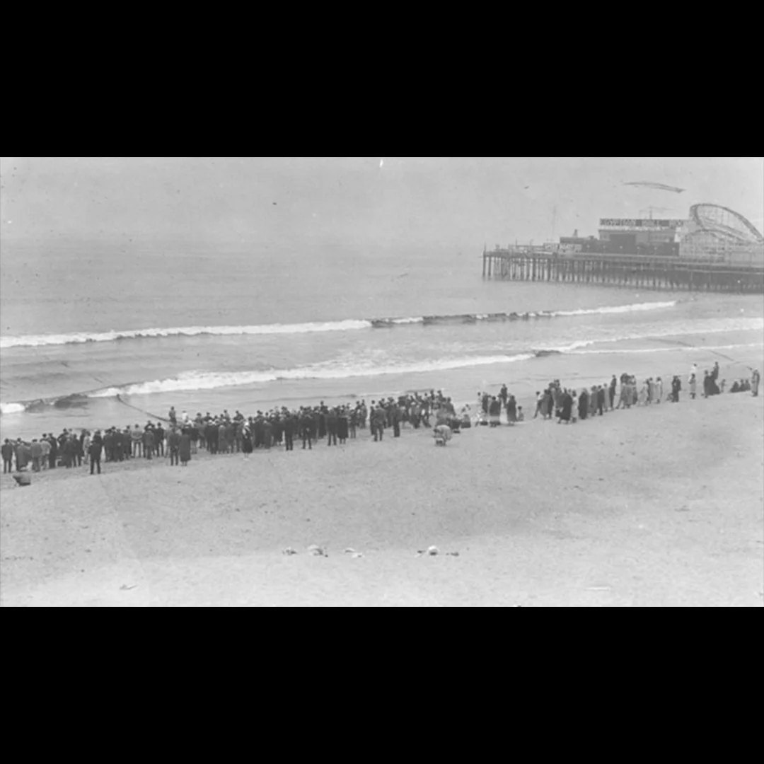 People praying and searching the beach for Aimee