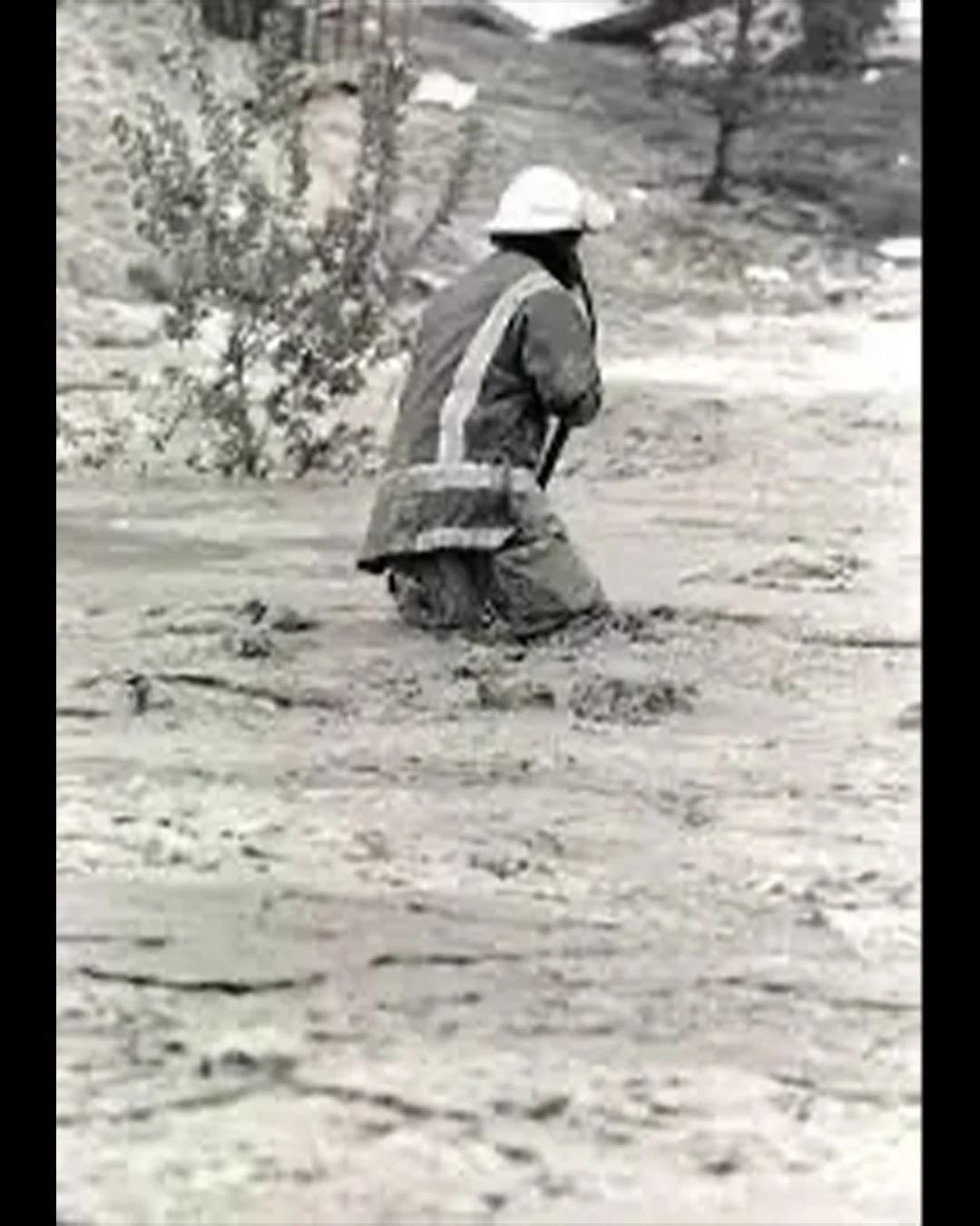 A fireman walks in hip-deep dairy