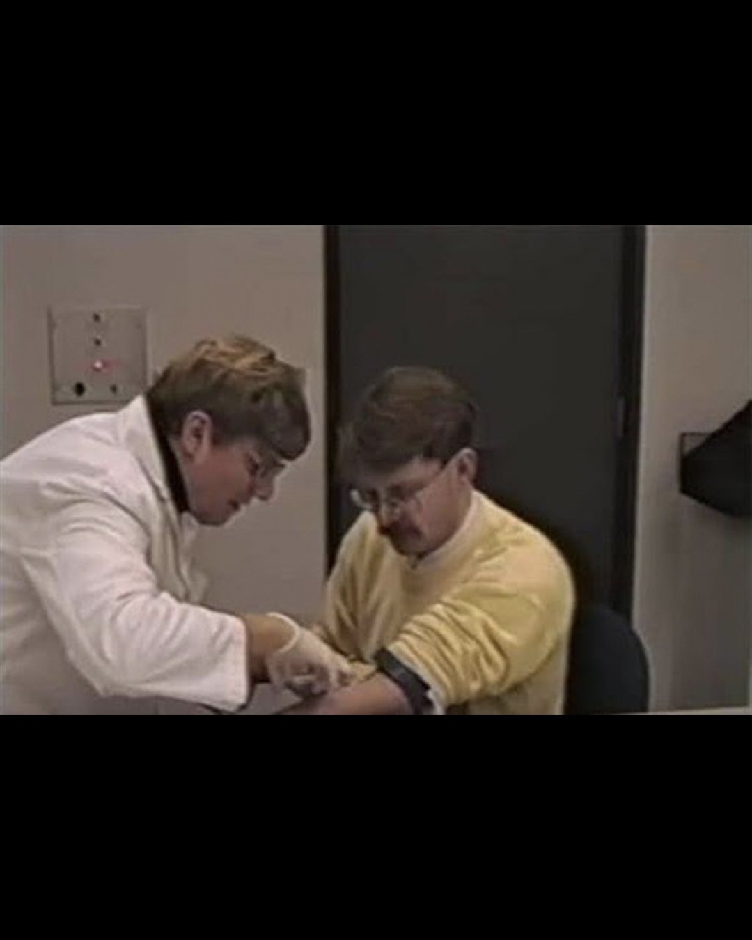 Still image from the recorded footage of Dr. John Schneeberger providing a blood sample in 1996