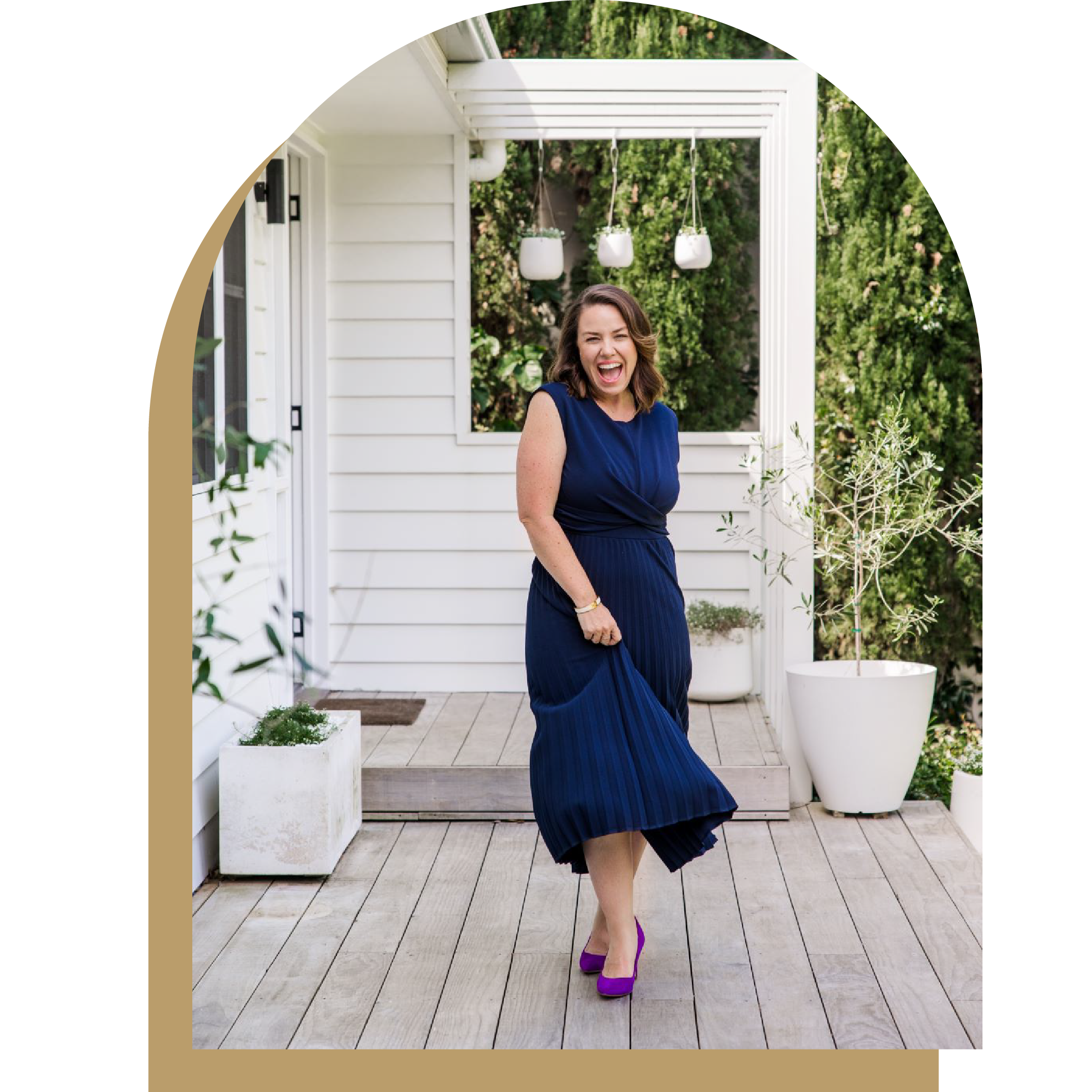 Joyful personal branding photo of Tina Tower, founder of Her Business Empire, dancing in a navy dress, captured by Gold Coast photographer