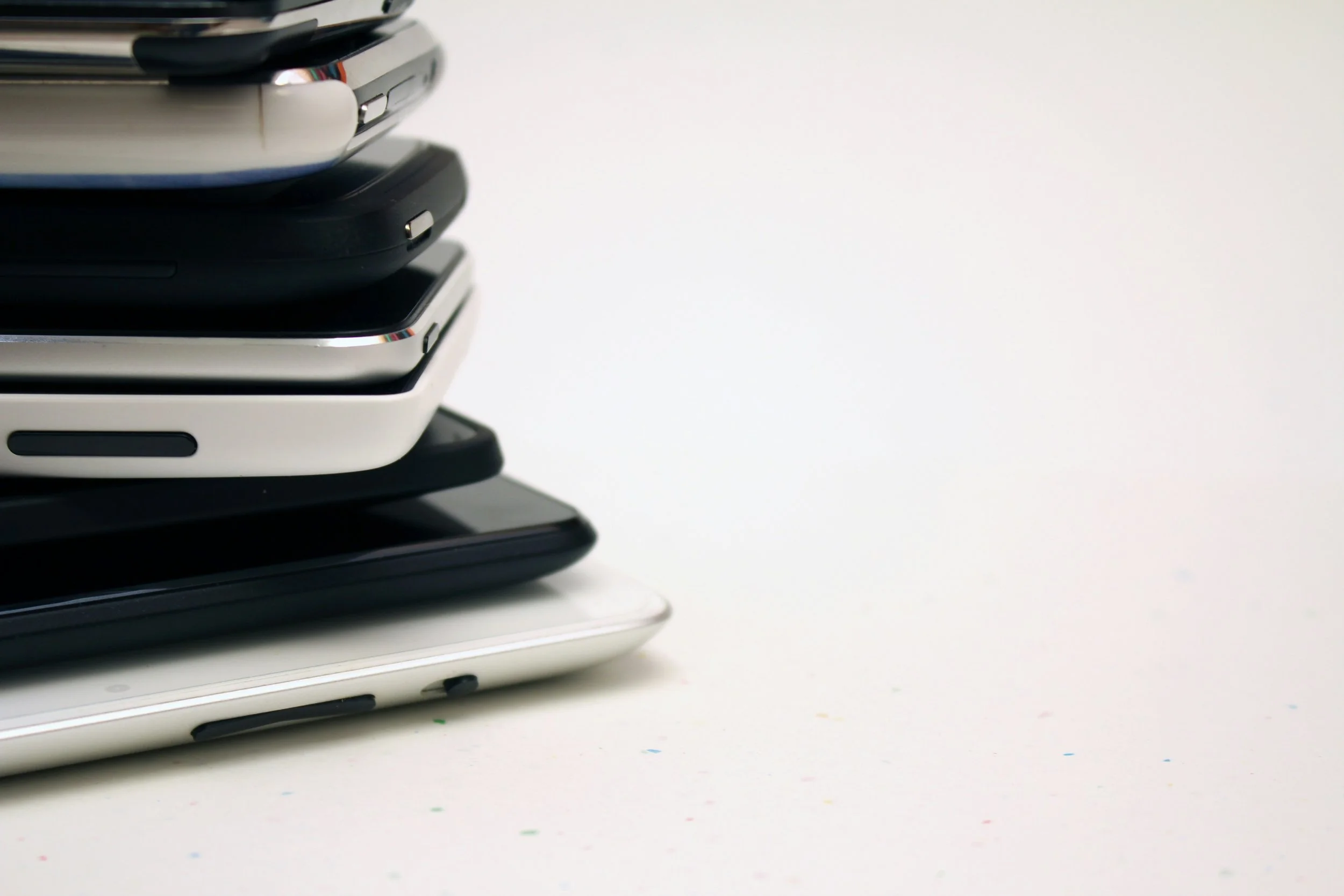 A stack of smartphones against a white background