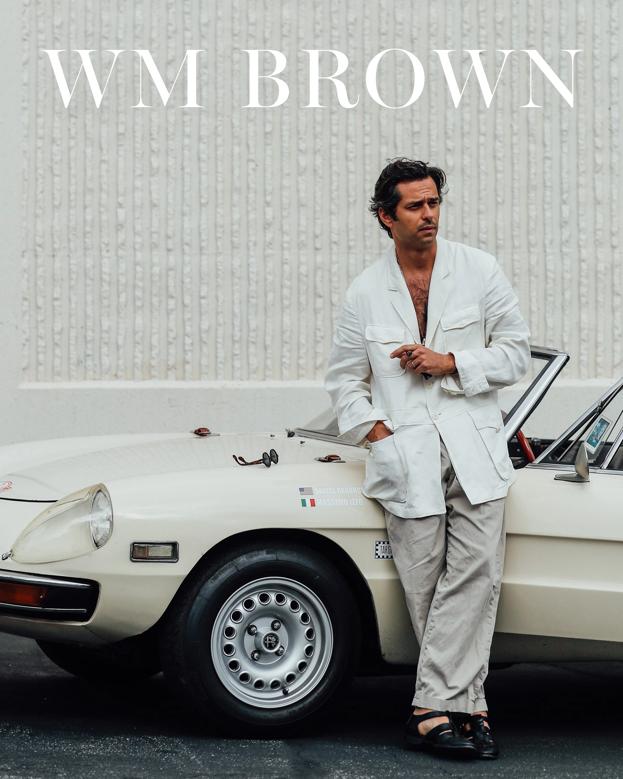 Portrait of Davide Baroncini, founder of Ghiaia Cashmere, photographed in Pasadena, Los Angeles. The image blends relaxed tailoring, vintage automotive elements, and a distinctly West Coast aesthetic