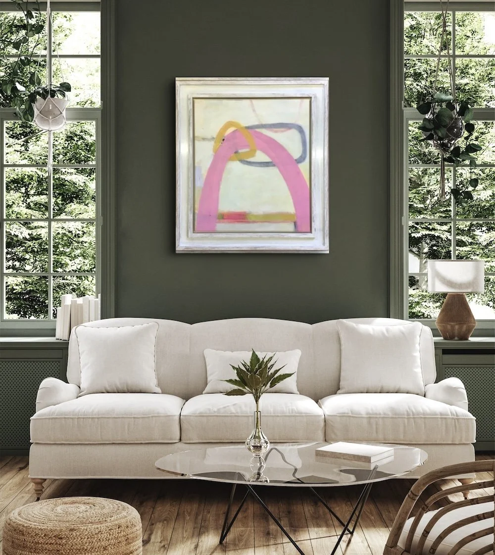 Follow The Sun abstract painting with pink by Trudie Tara Moulton on green wall above white sofa and palm.JPG