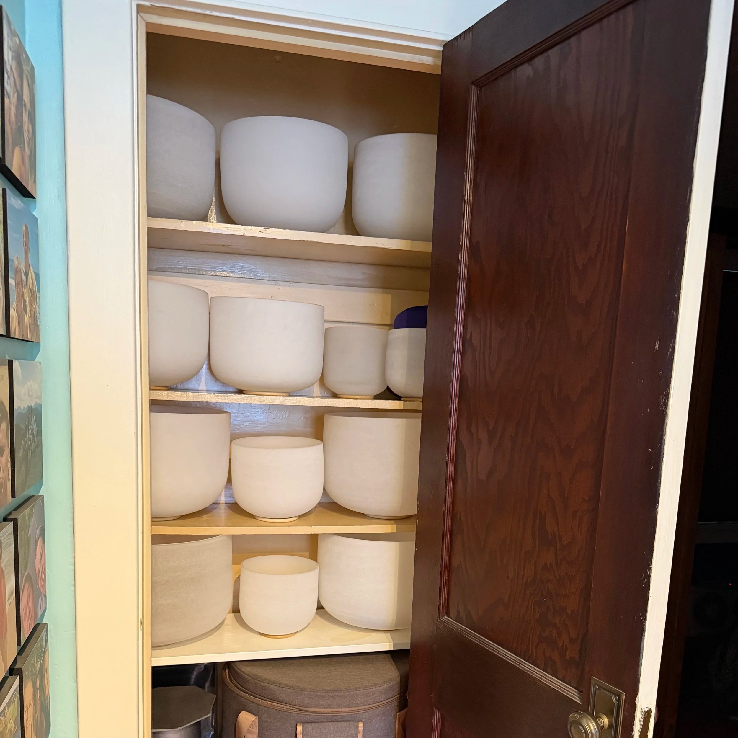 A photo of a hall closet filled with crystal bowls.