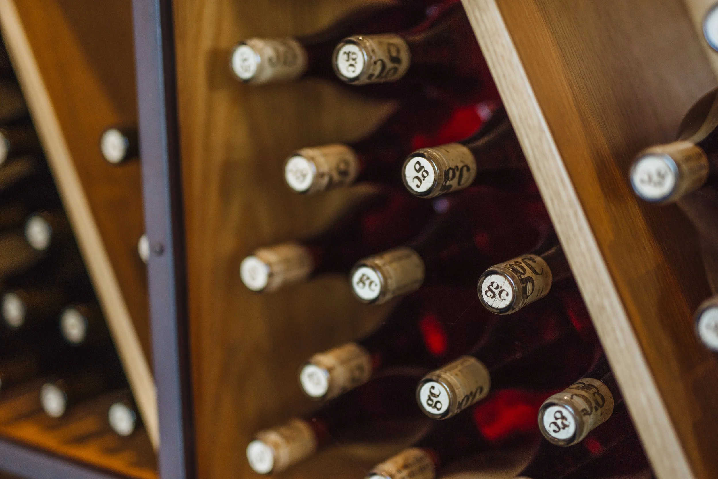 GC Wine Bottles on shelves in tasting room  .JPG