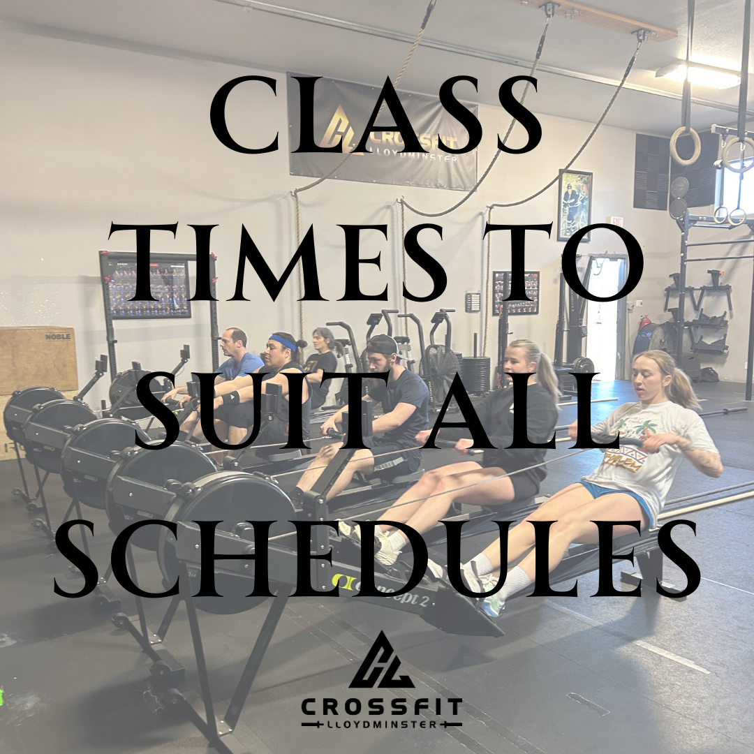 People participating in a rowing class at a gym with fitness equipment and gymnastic rings, overlaid with text saying 'Class times to suit all schedules' and a CrossFit Lloydminster logo.