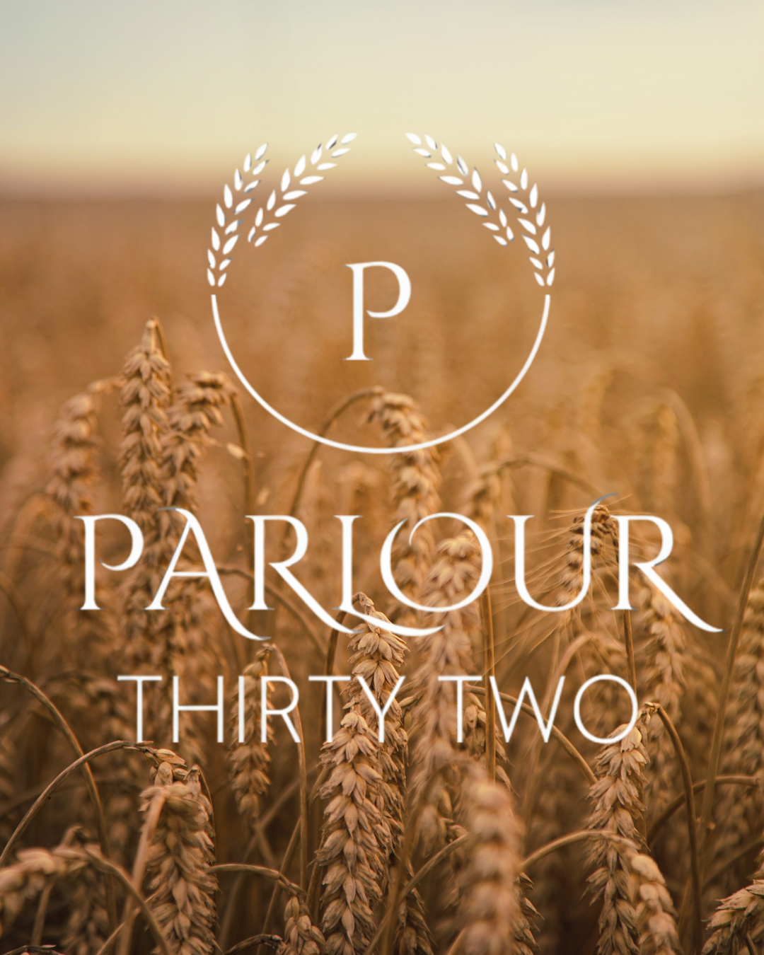 Field of wheat with a logo reading 'Parlour Thirty Two' in white overlay.