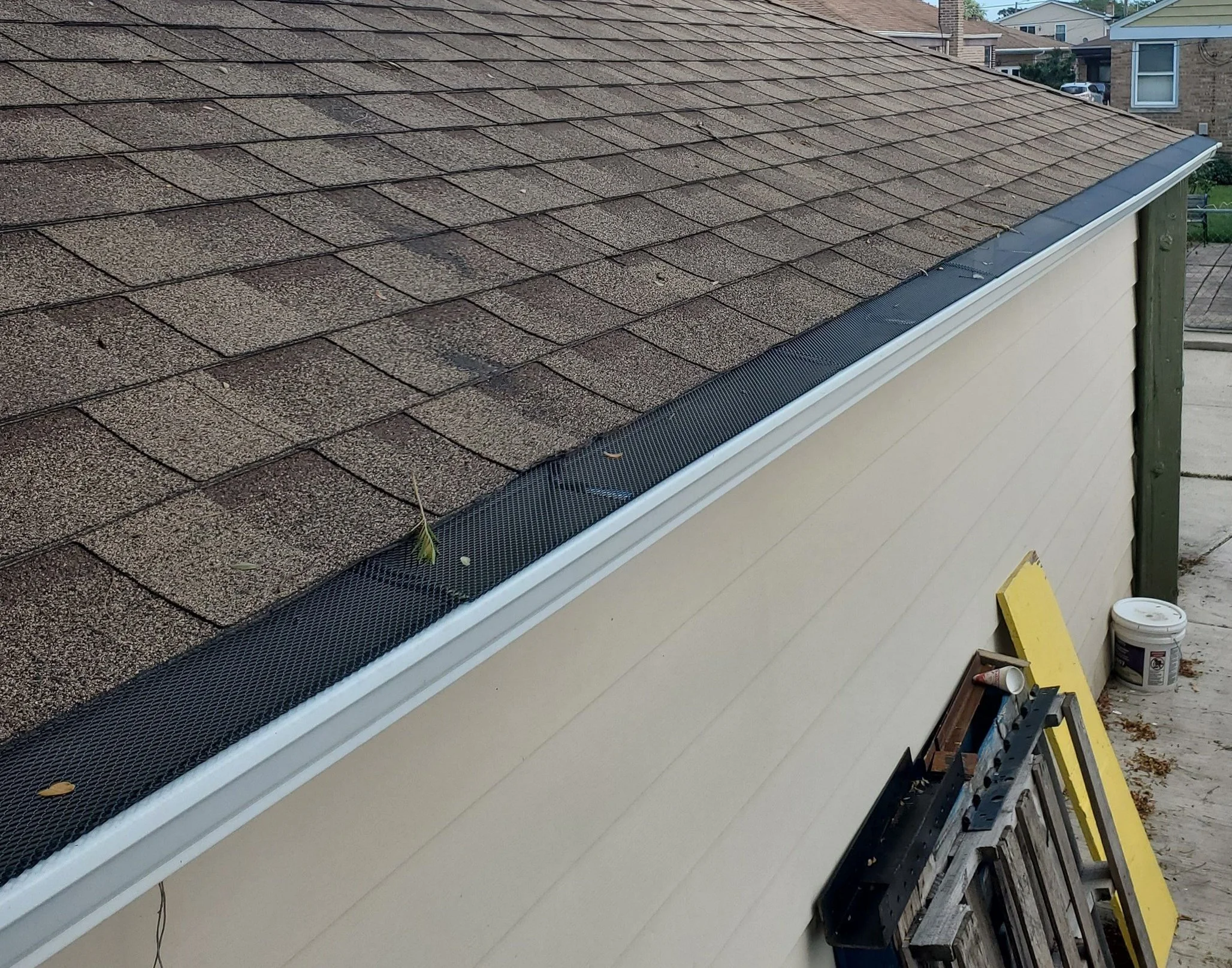 House roof with shingle tiles and gutter guards