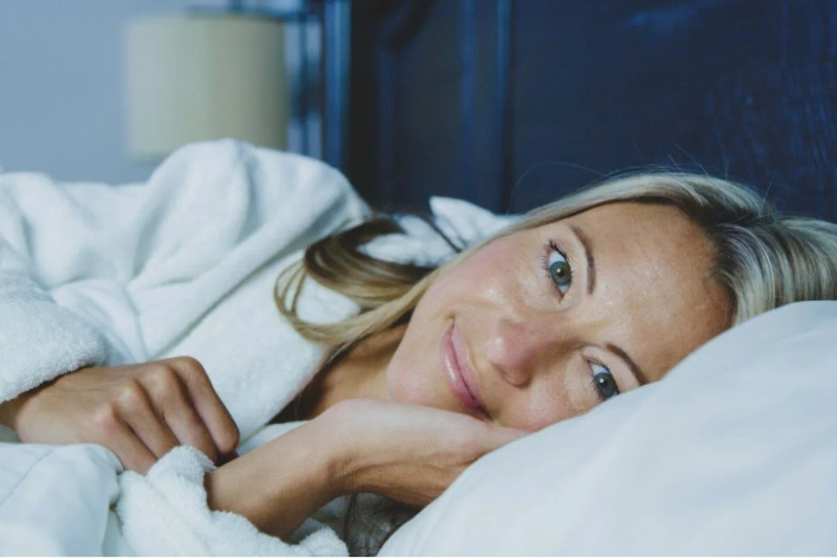 Woman lying on her bed