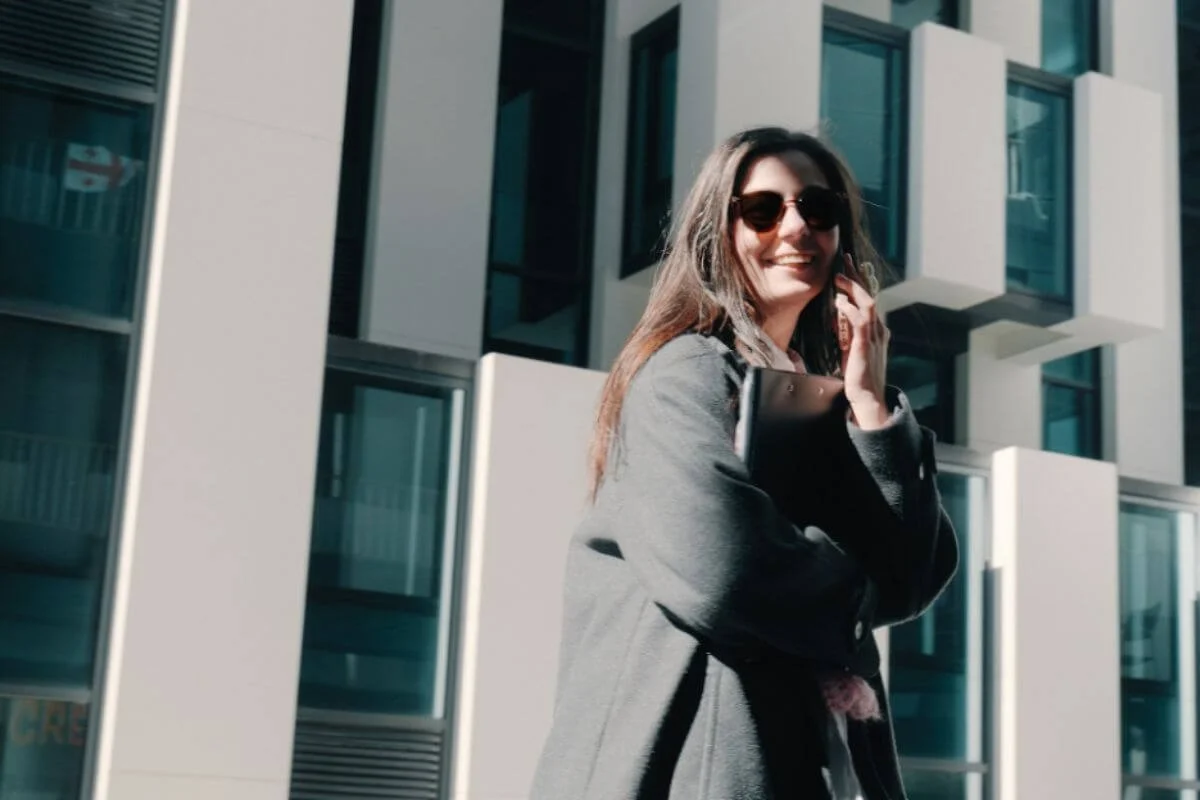Woman smiling while on the phone walking