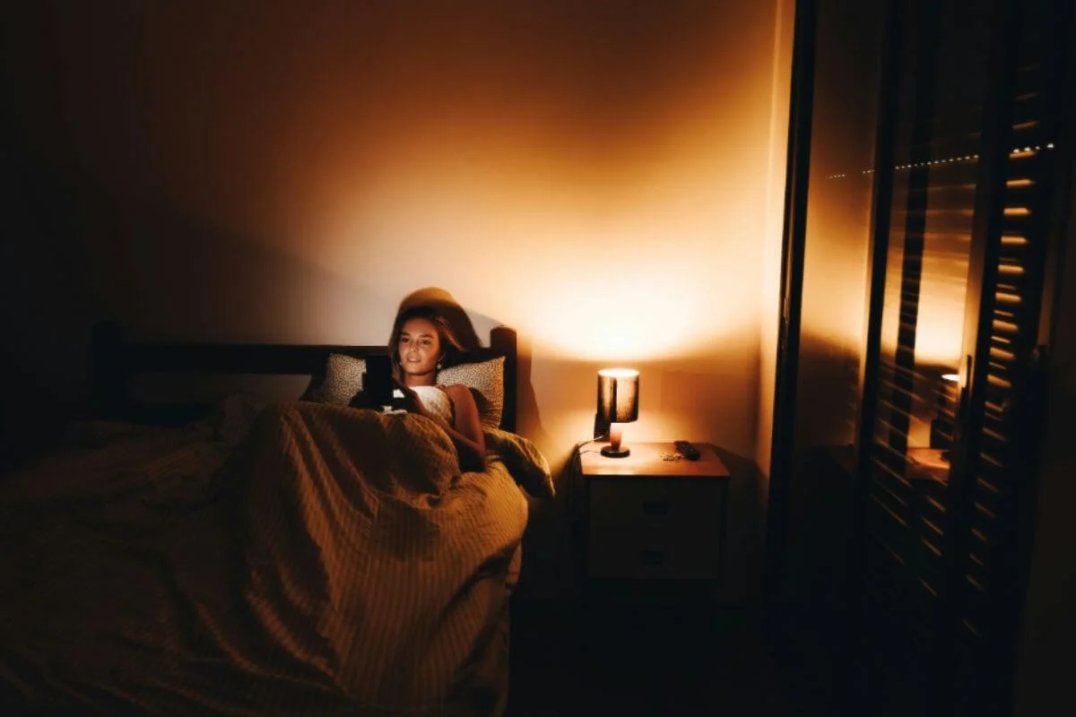 A woman late at night still on the phone