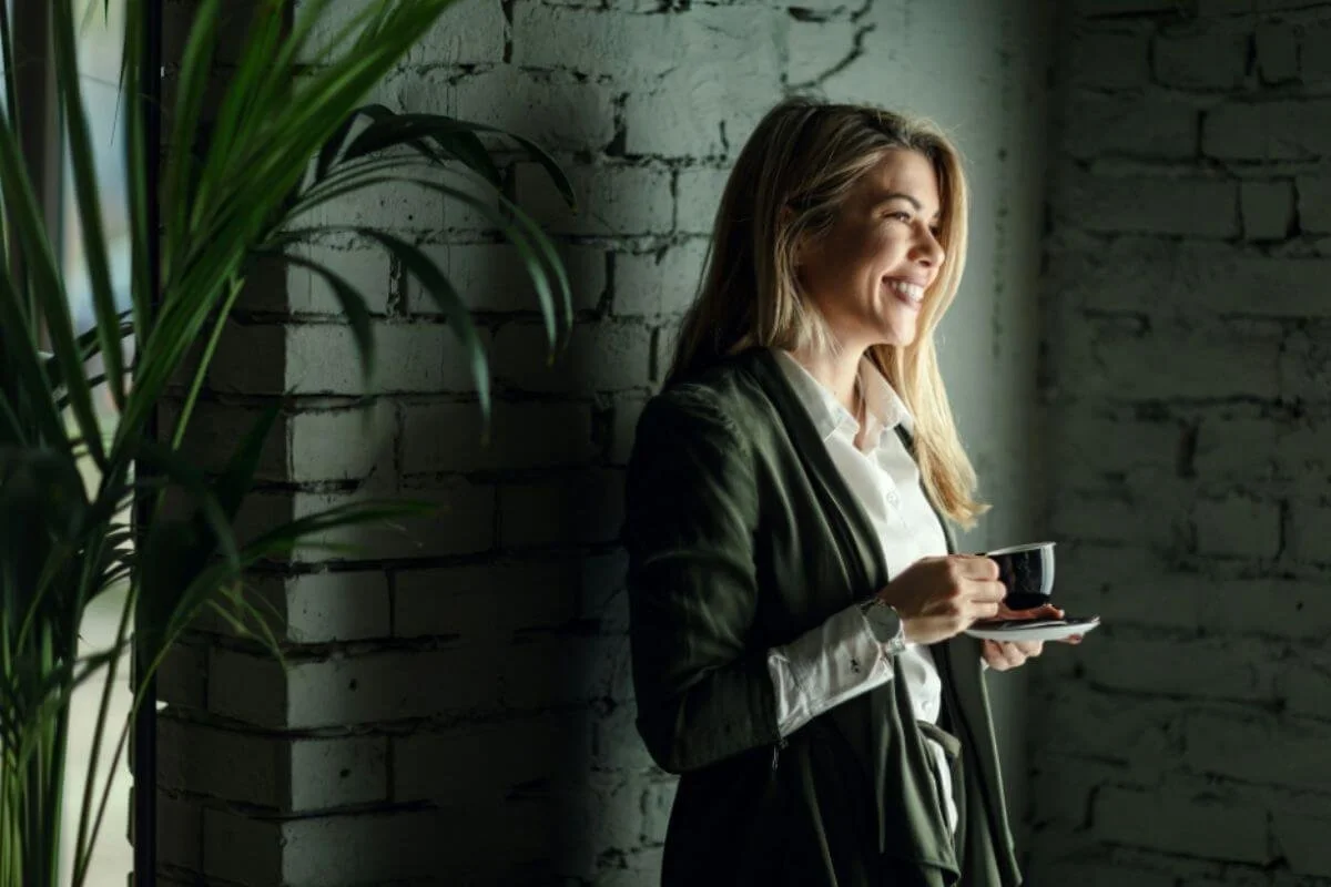 A woman holding a cup of coffee