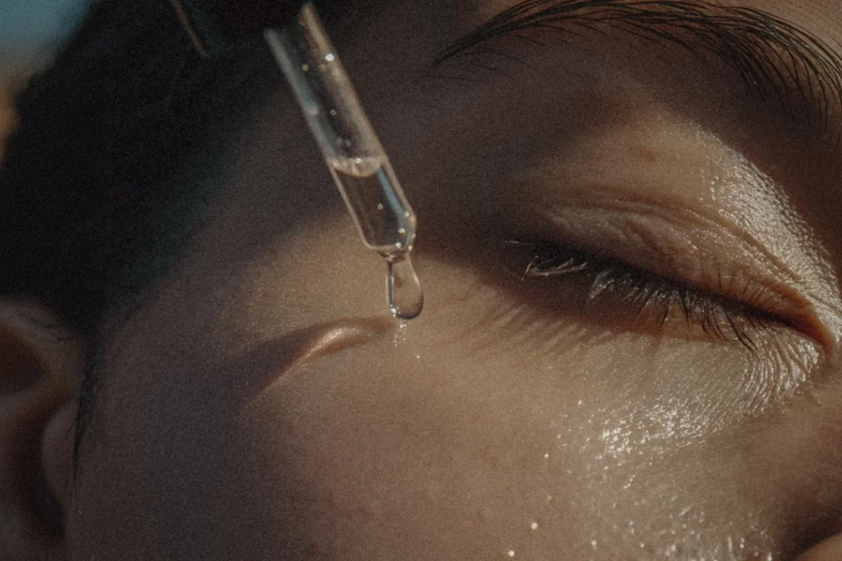applying a drop of serum in the upper cheek
