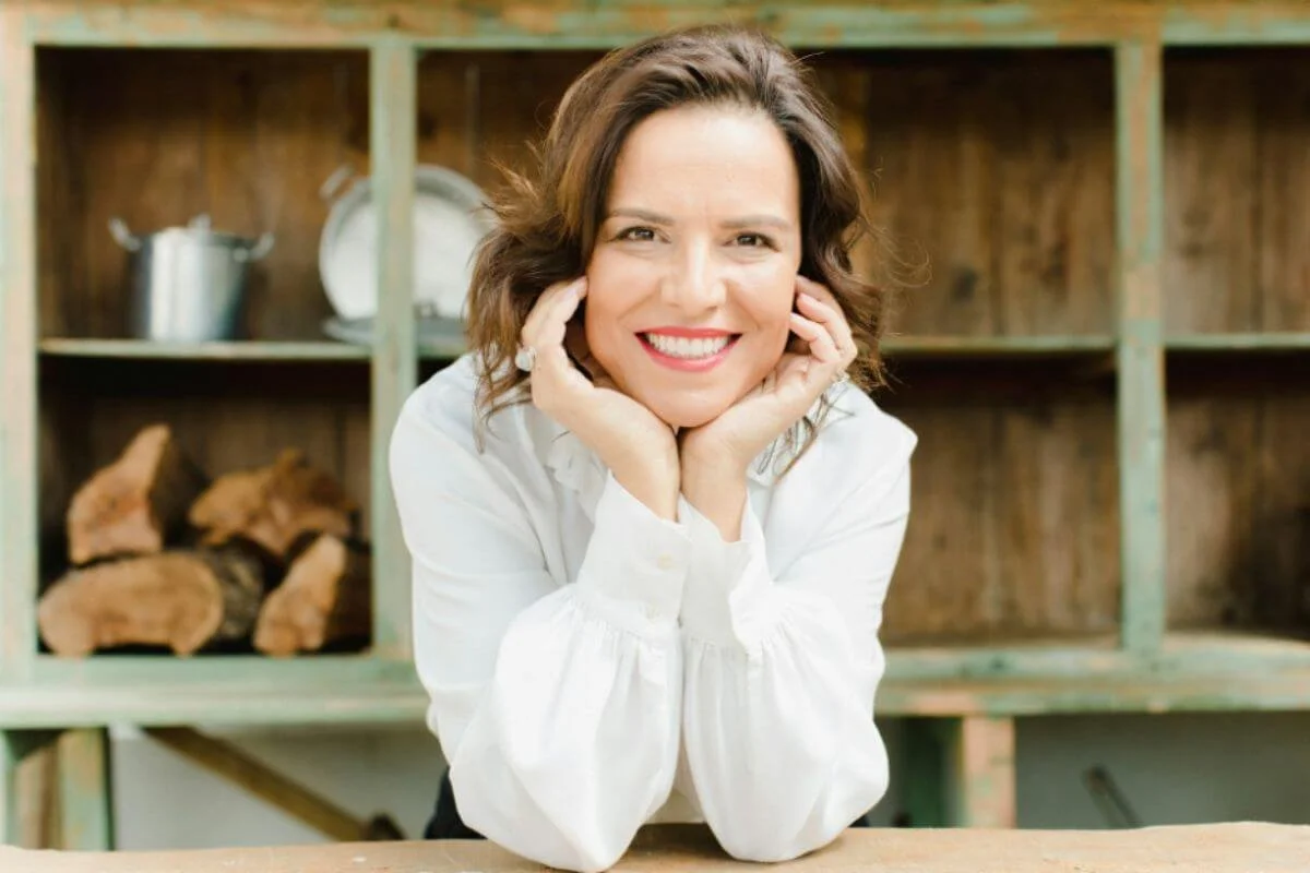 A woman wearing a white clothing while smiling