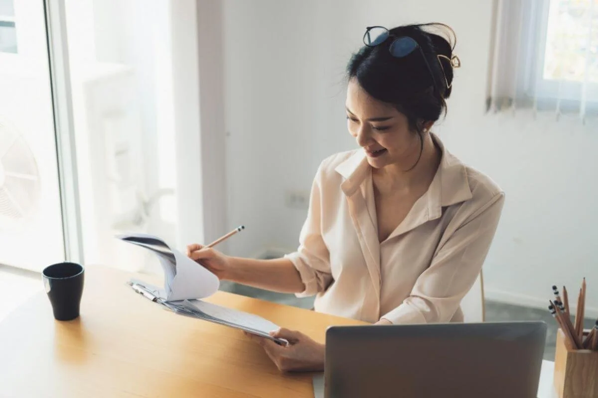 Woman reviewing health notes and records, taking a personalized approach to understanding her own biology