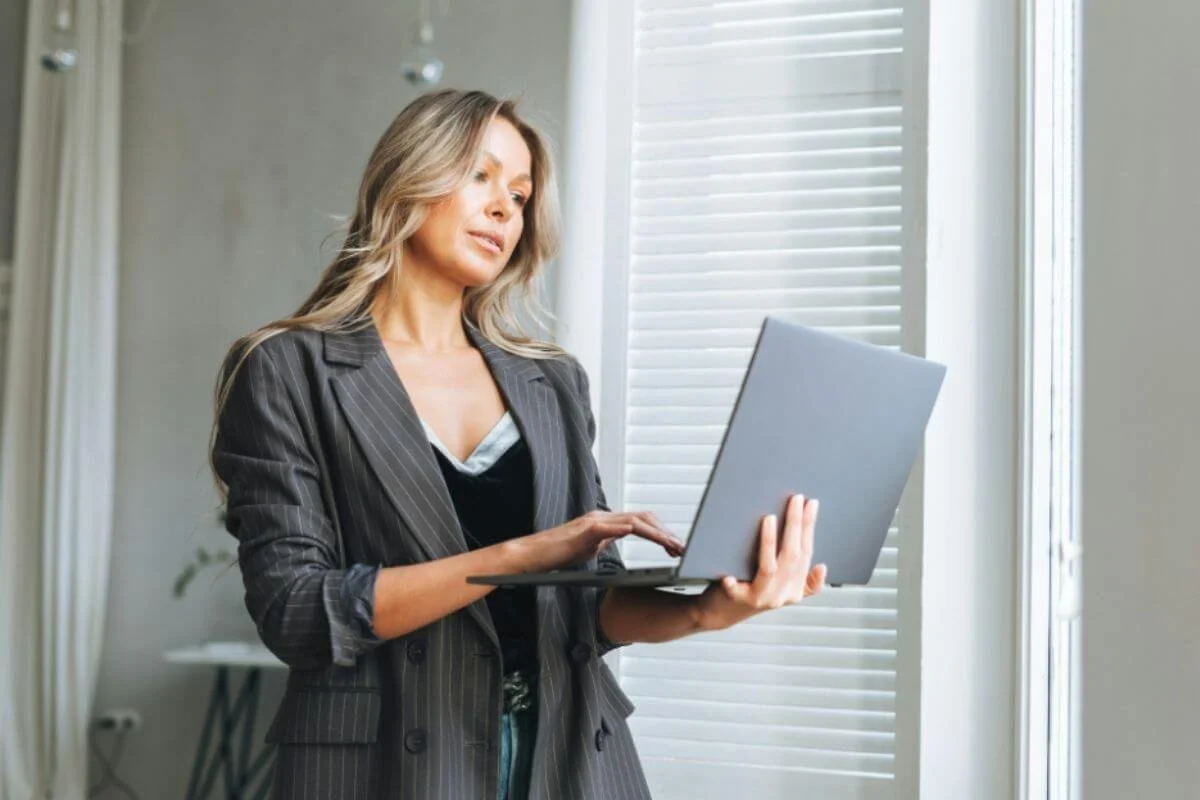 Woman carrying her laptop and typing
