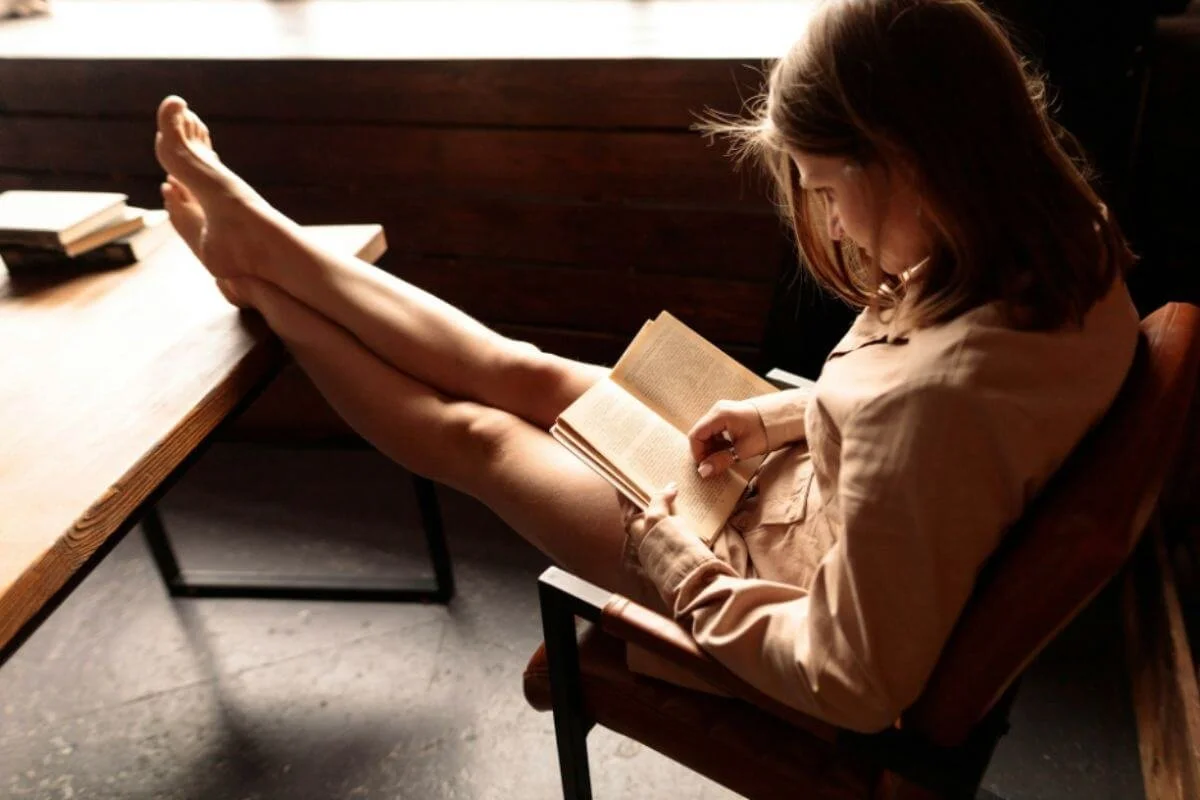 Woman reading a notebook while sitting