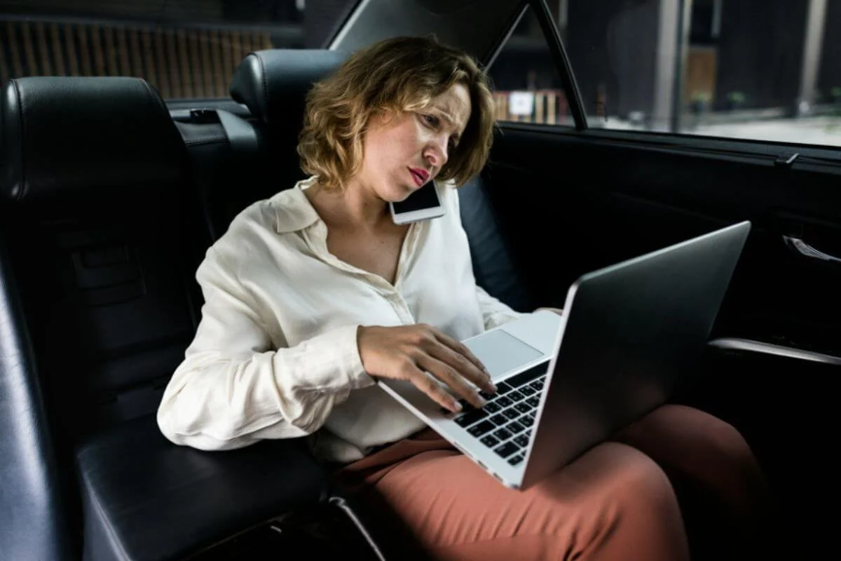 Woman in her laptop and on a phone call