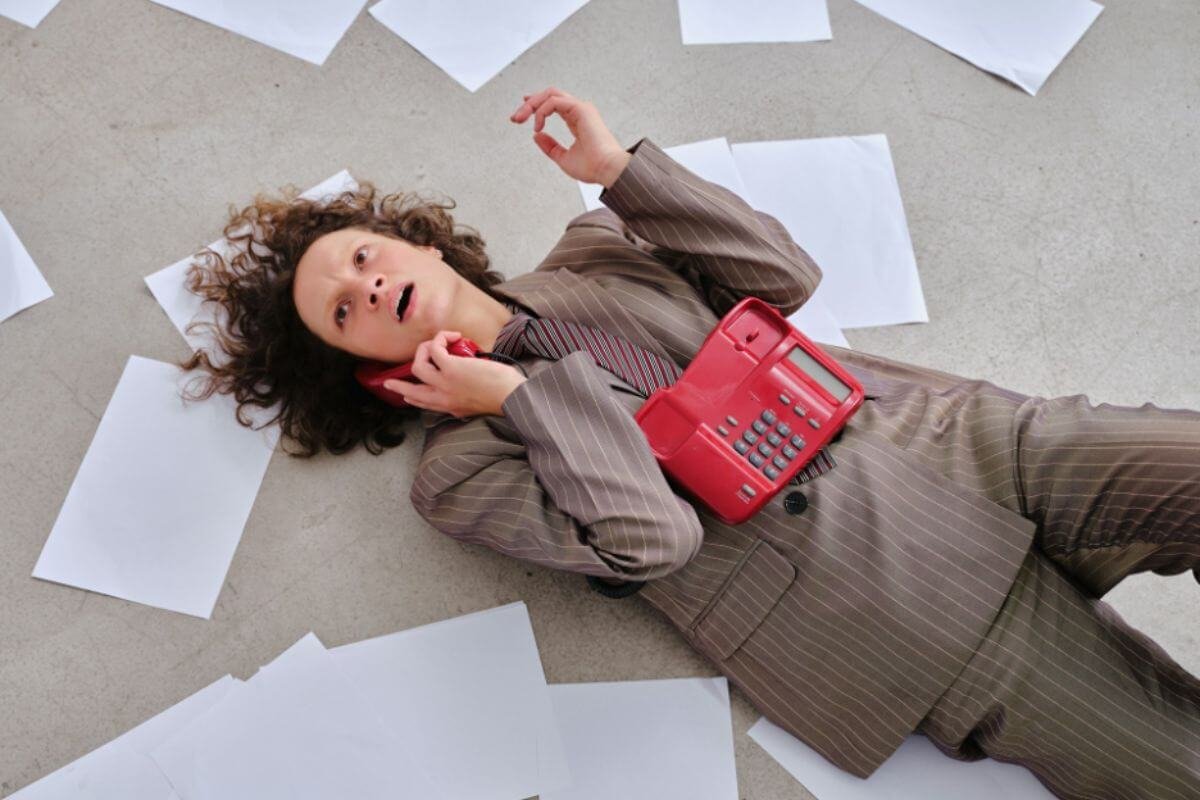 A woman lying on the floor while on the phone