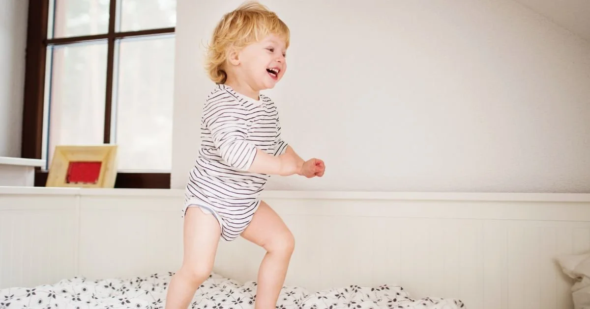 Hyper child running on bed at bedtime