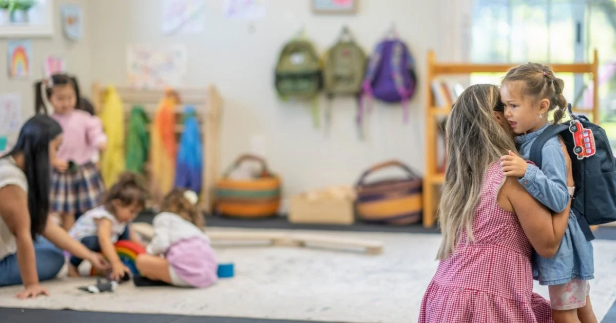 Child hugging mom at preschool drop off