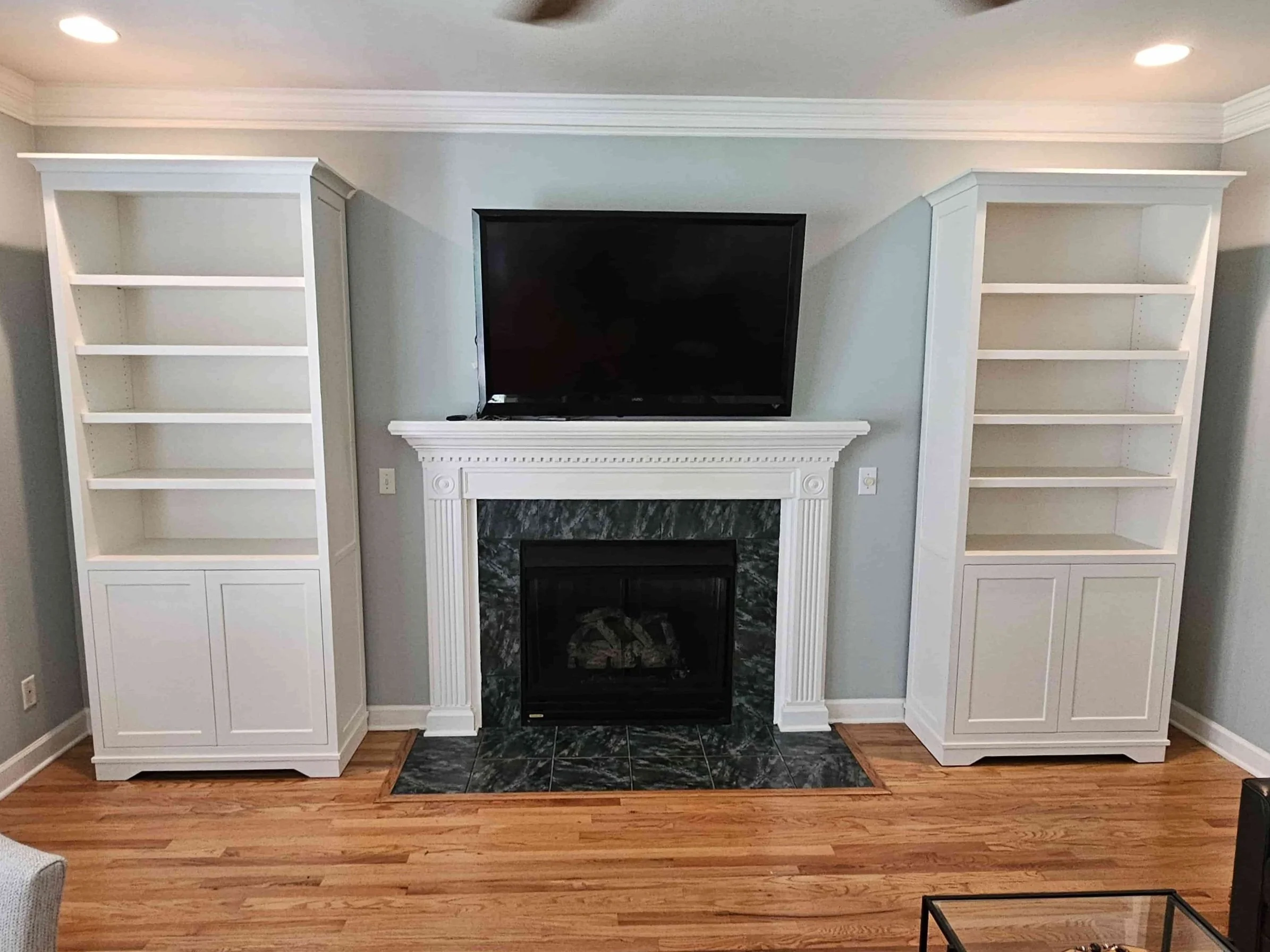 Installed bookcases flanking fireplace