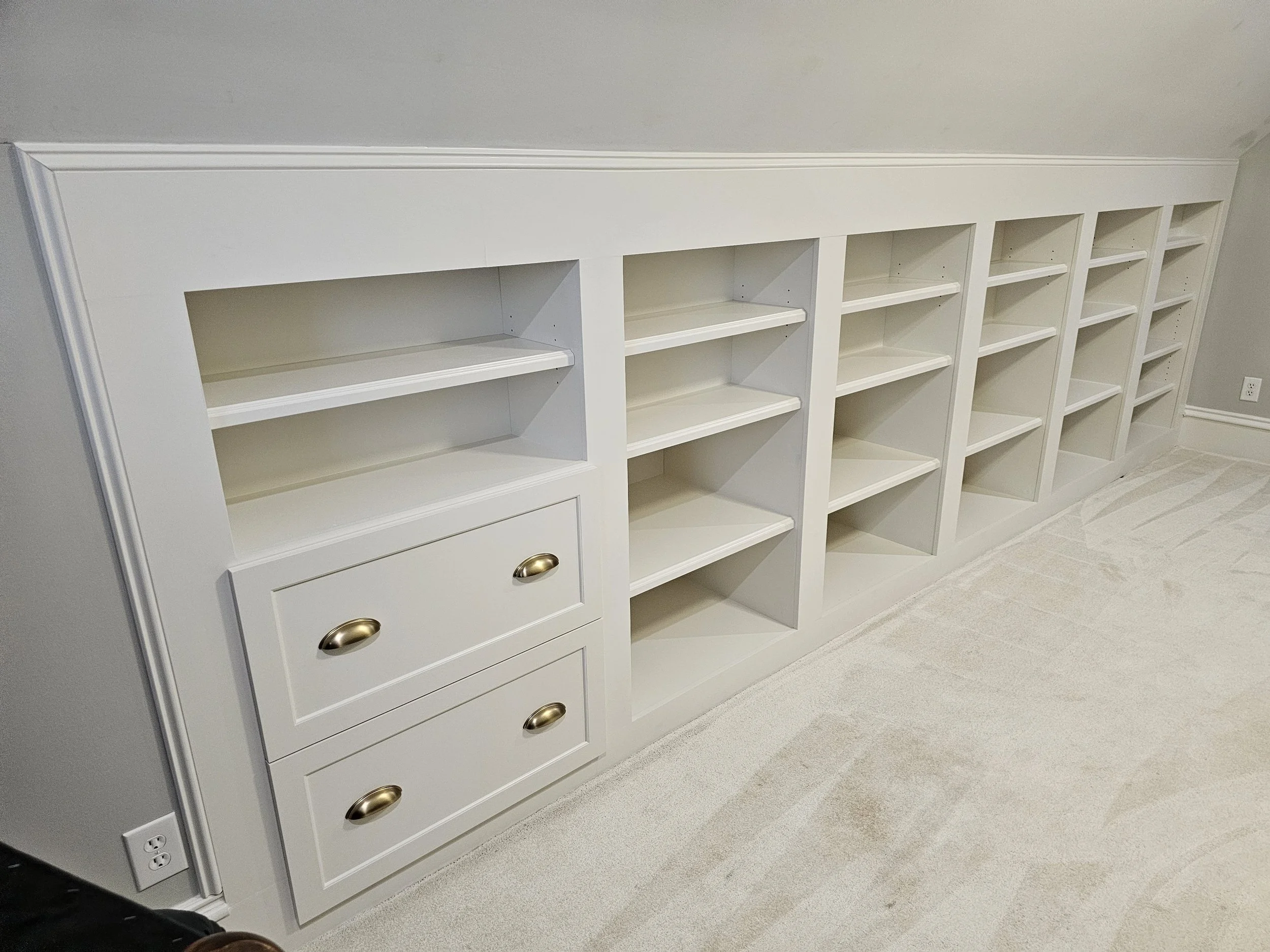 White lacquered built in storage cabinetry with file storage