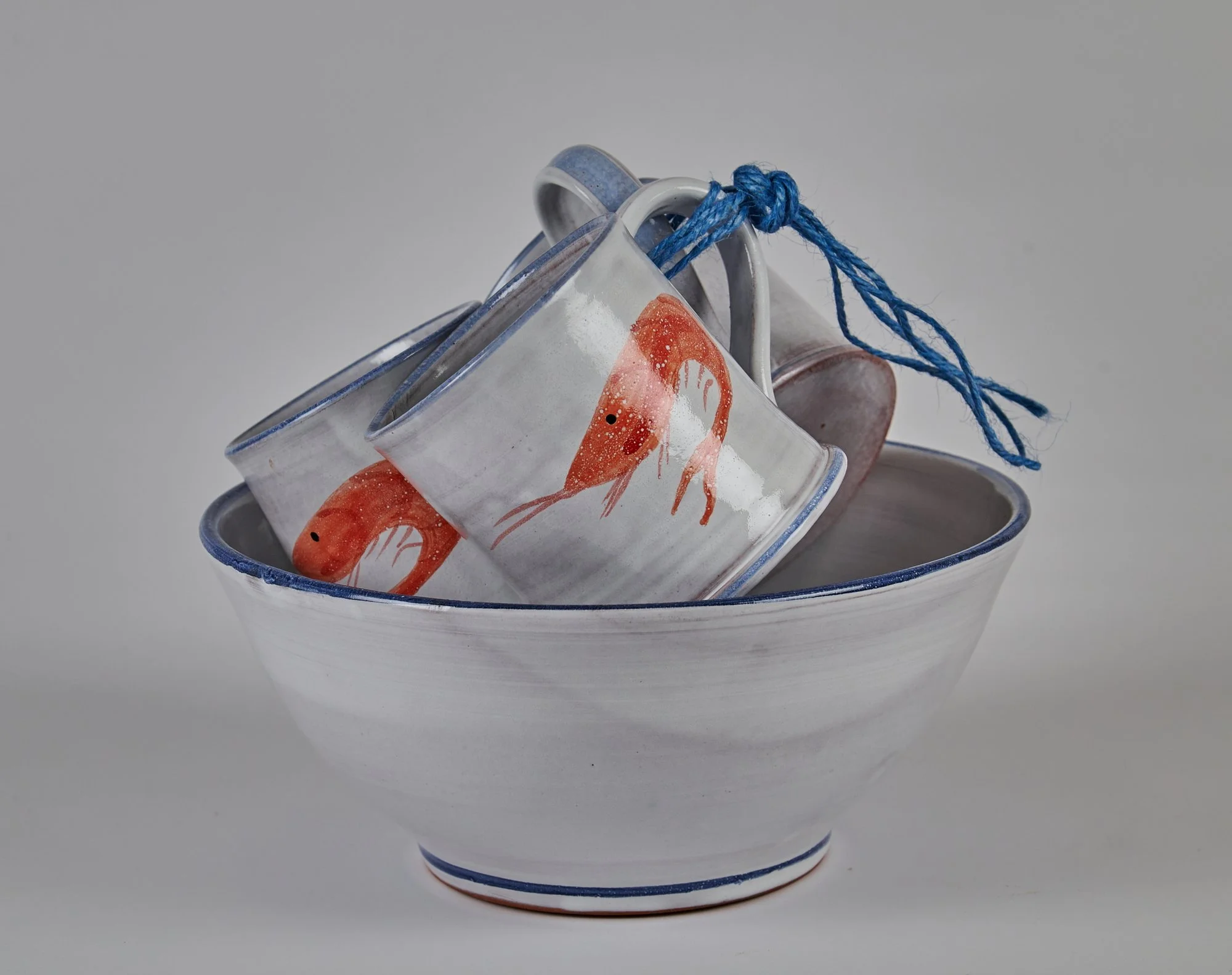 Shrimp mug family stack with blue string in large bowl.jpg
