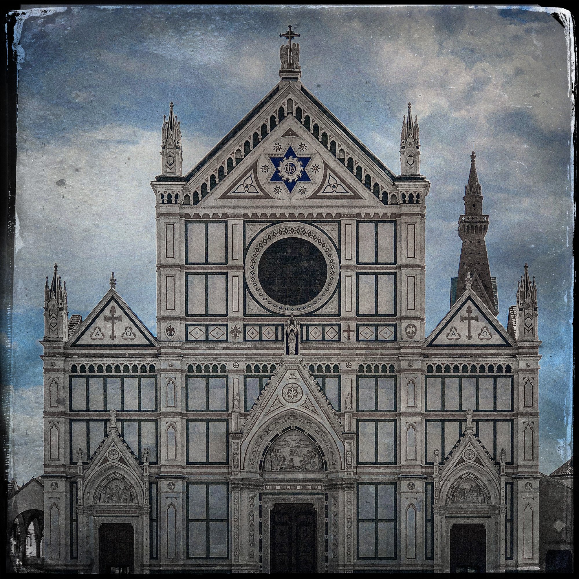 Front view of the historic Cathedral of Santa Maria del Fiore in Florence, Italy, showcasing its ornate Gothic facade and detailed architecture against a cloudy sky.
