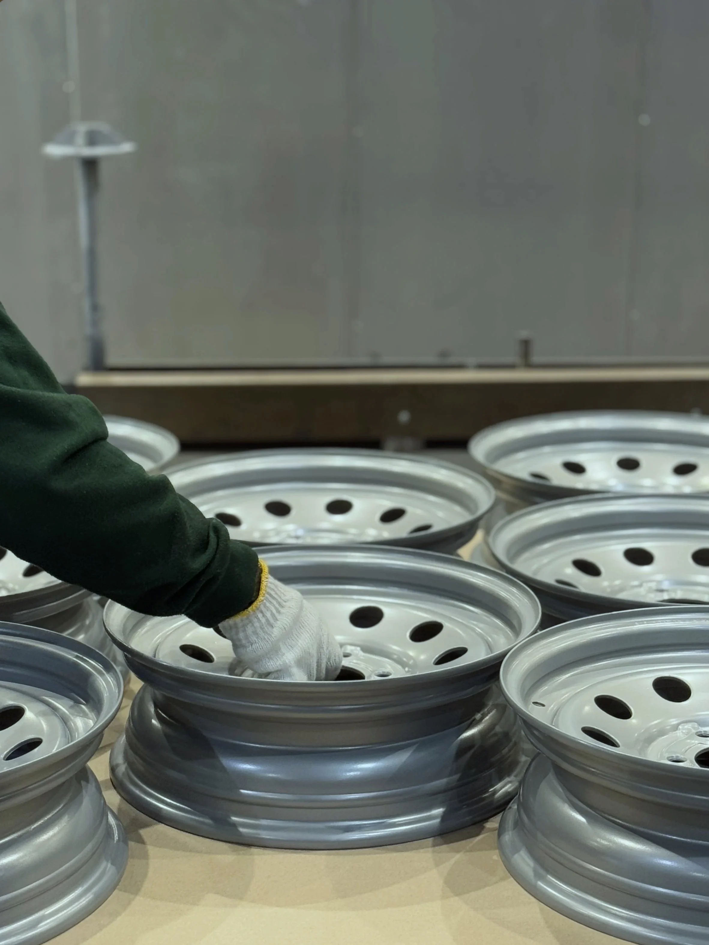 White Glove Handling of silver steel trailer wheel